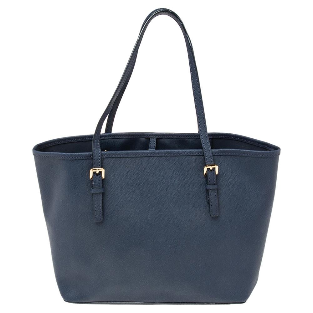 This Michael Kors tote is beautiful in so many ways. From its design to its structure, the Saffiano leather bag exudes charm and high fashion. It flaunts two shoulder handles for you to swing and a spacious interior to hold all your