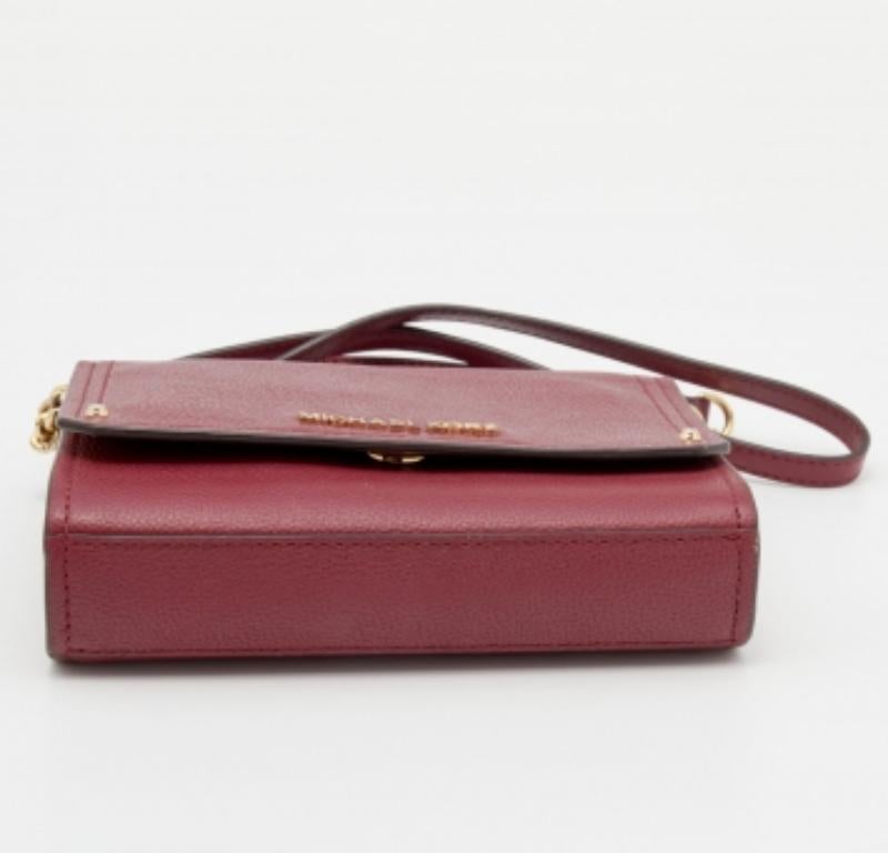 This Jet Set crossbody bag from Michael Kors is beautiful and functional in so many ways. From its design to structure, this bag exudes charm and high-quality fashion. It is made using burgundy leather on the exterior and displays a gold-toned logo