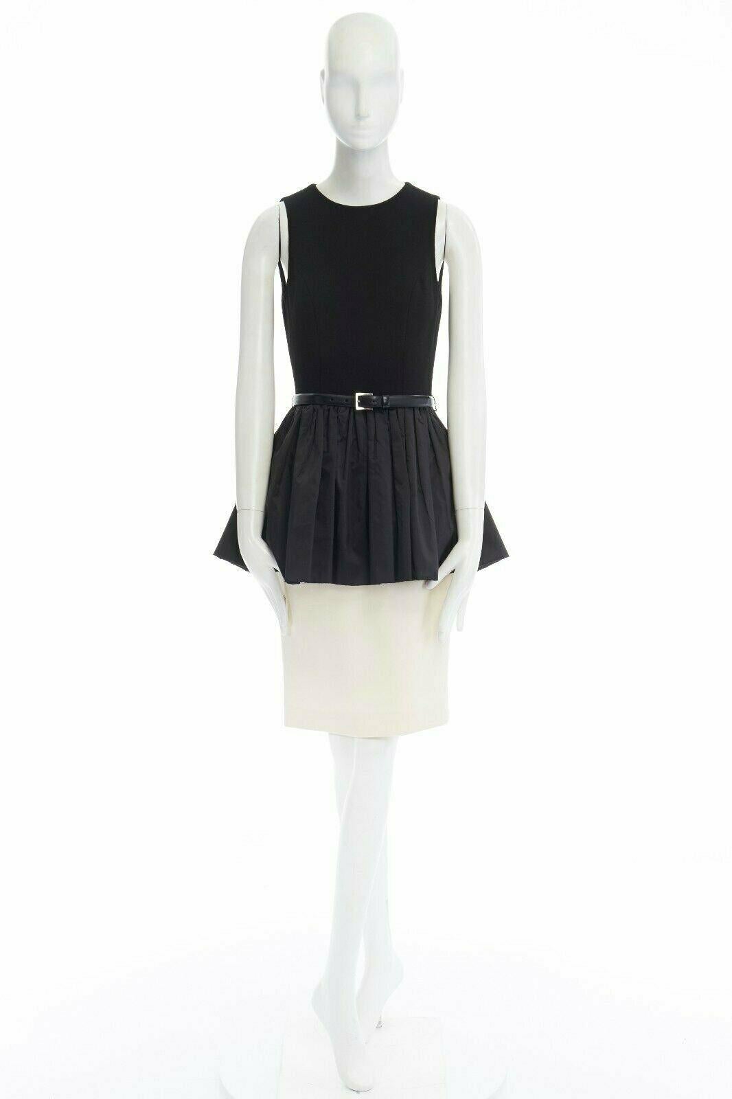 MICHAEL KORS COLLECTION black leather belted peplum white skirt dress US2 XS 
Reference: LNKO/A00691 
Brand: Michael Kors 
Material: Virgin Wool 
Color: Black 
Pattern: Solid 
Closure: Zip 
Extra Detail: Virgin wool, spandex, rayon, polyester. Black
