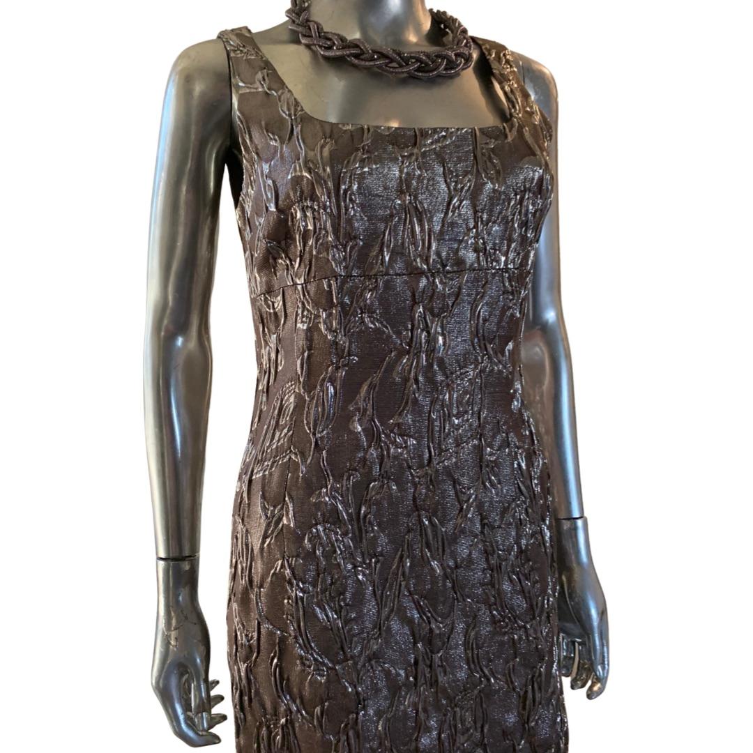 This dress way from the Michael Kors collection made in Italy. Very high end it retailed over $1500. Brilliantly cut and the fabric is spectacular. It is an Italian embossed floral metallic jacquard blend of silk, wool and other fibers. A