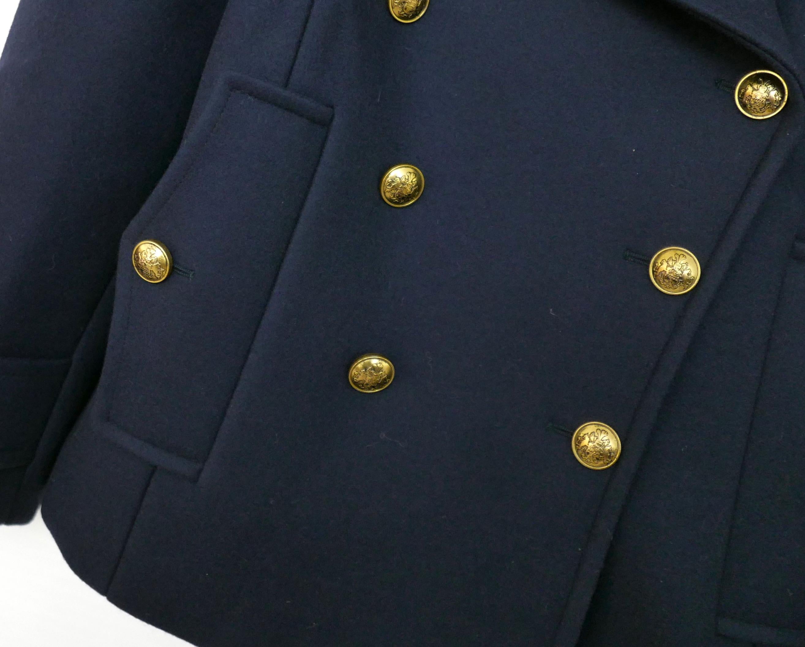 Super luxe classic with a twist pea coat from the Michael Kors Collection AW19 runway - bought for £2500 and new with tags and spare buttons. 

Made from super dense, heavy and smooth navy wool with soft navy satin lining with gold-tone heraldry