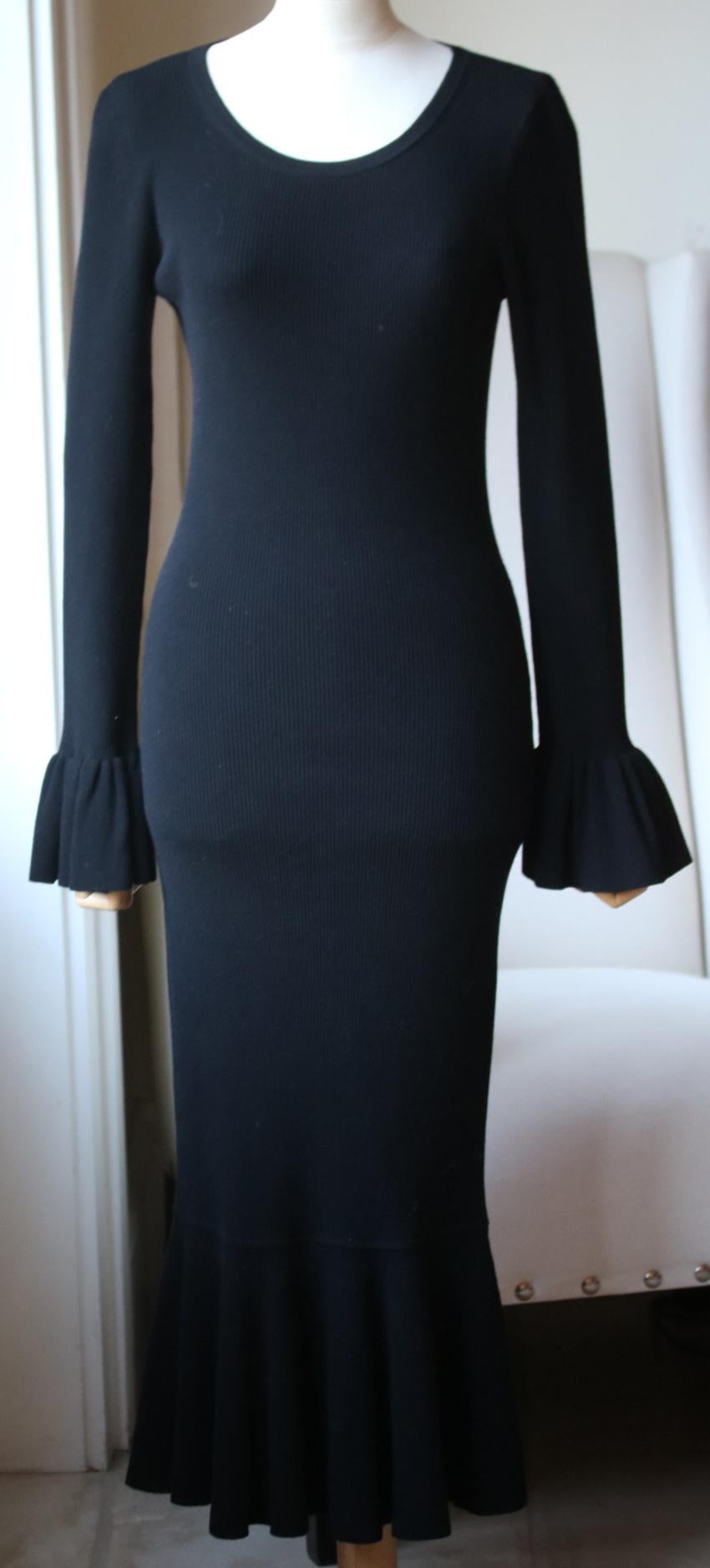 This midi dress is made from ribbed stretch-knit for a body-sculpting fit defined with pretty ruffled edges. Black ribbed stretch-knit. Slips on. 82% viscose, 18% polyester. 

Size: Medium (UK 10, US 6, FR 38, IT 42)

Condition: As new condition, no