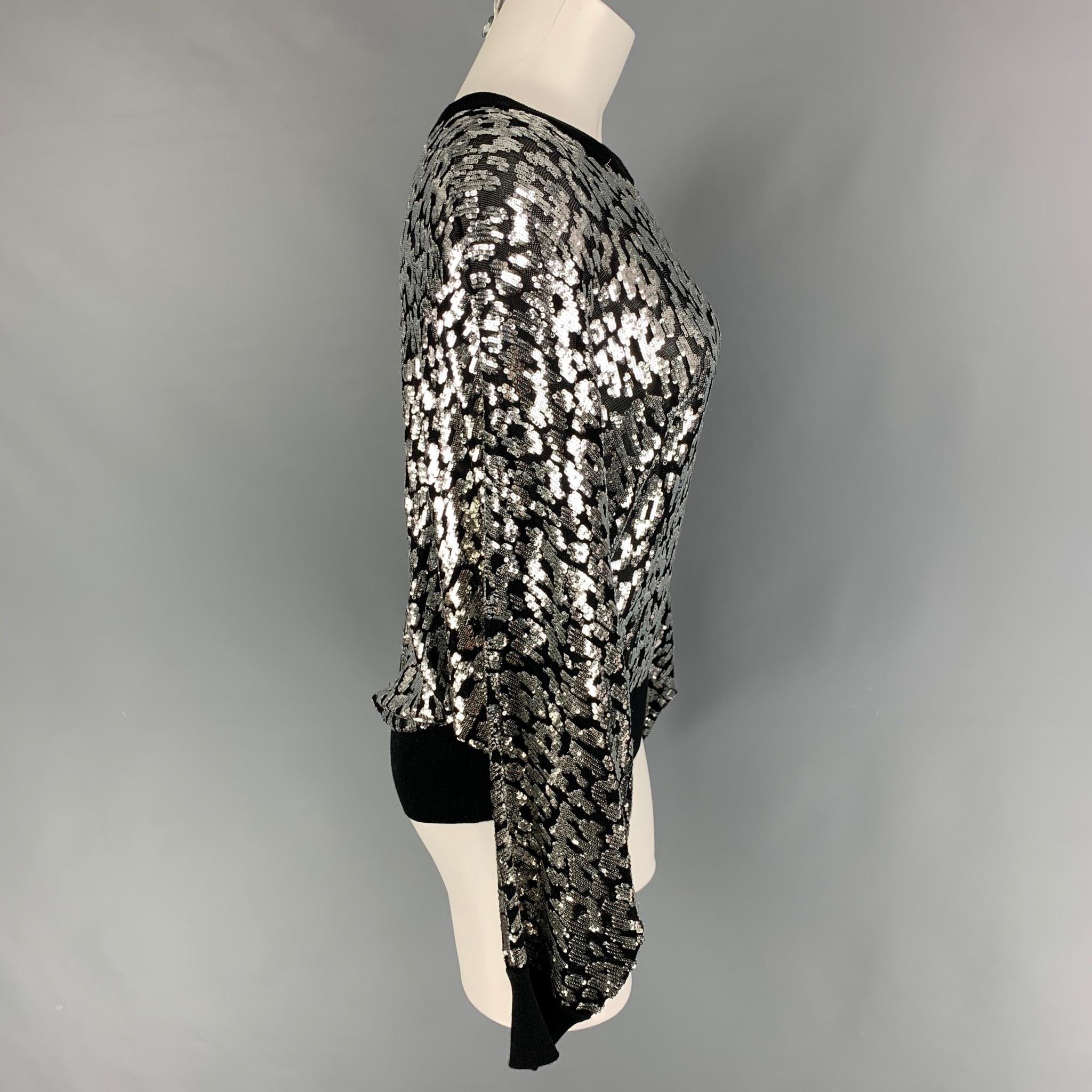 MICHAEL KORS COLLECTION pullover comes in a black & silver sequin viscose featuring a bat wing and a crew-neck. 

Excellent Pre-Owned Condition.
Marked: M

Measurements:

Shoulder: 16.5 in.
Sleeve: 27 in.
Length: 22 in. 