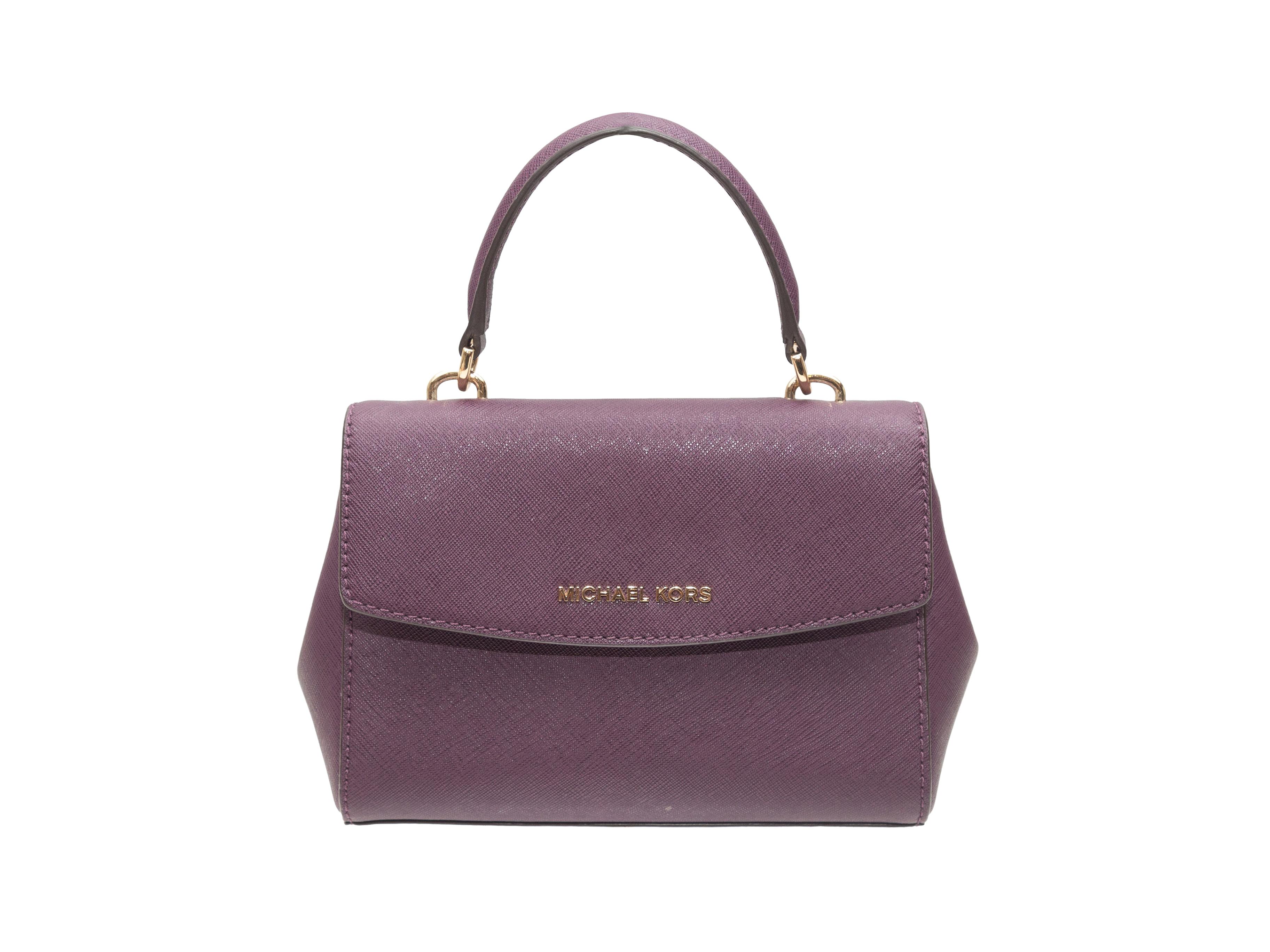 Product Details: Eggplant Michael Kors Leather Mini Handbag. This handbag features a leather body, gold-tone hardware, a single top handle, an optional shoulder strap, and front flap closure. 7