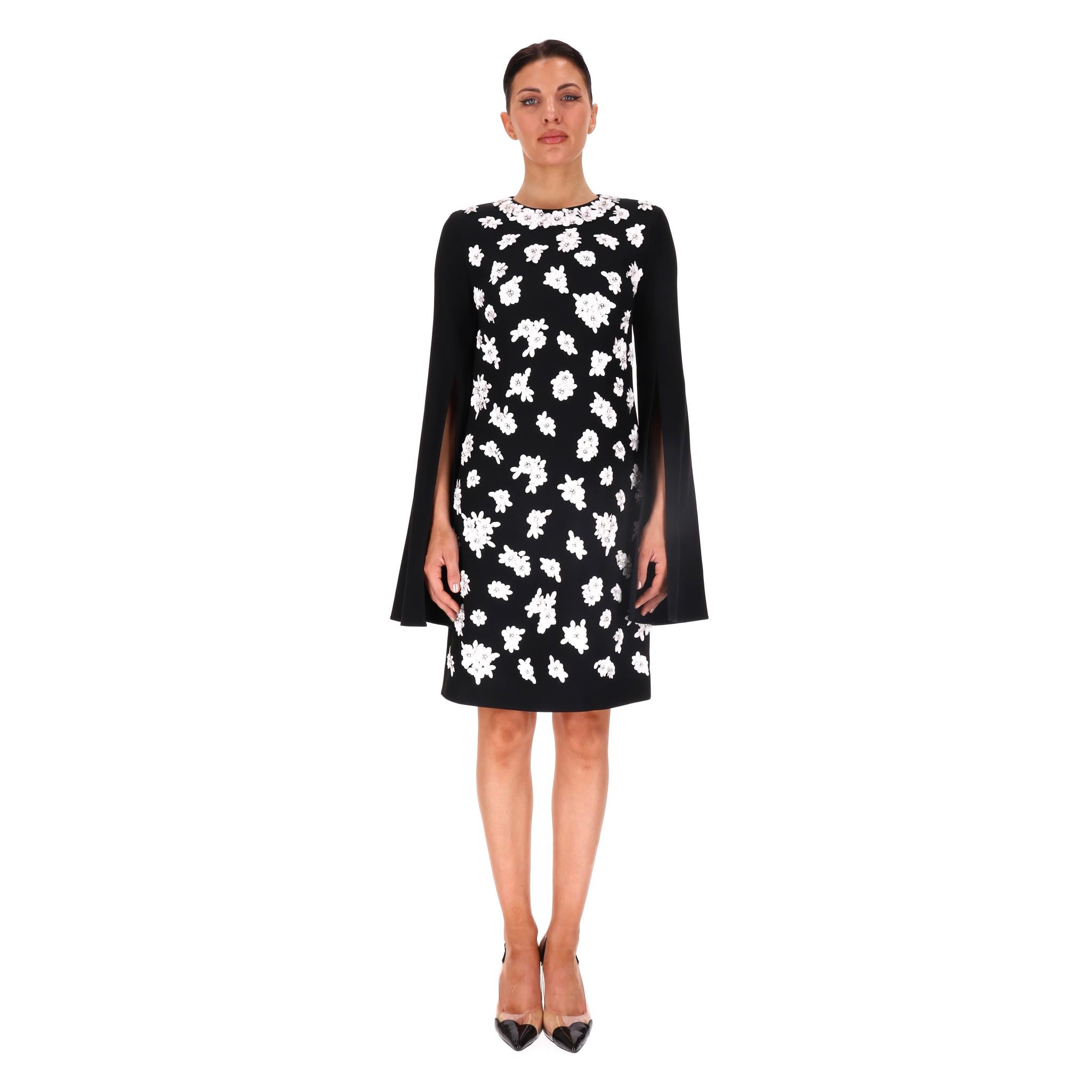 Michael Kors Vestido Adornado con Flores y Mangas con Abertura

Vestido negro adornado con apliques florales blancos en la parte delantera y el escote.

Con mangas largas con abertura y cierre de cremallera oculta en la parte trasera.

Precio aprox.