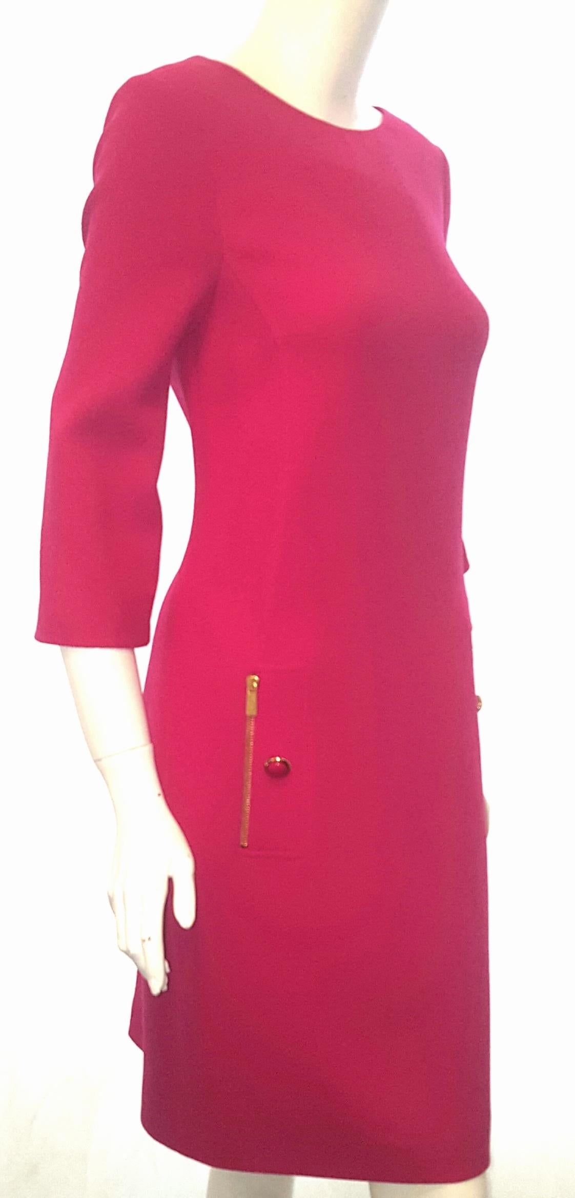 Michael Kors fuschia dress 3/4 sleeve includes side pockets with gold tone zipper and fuschia button on each pocket.  This jewel neckline dress is lined in pink silk.   This garment is in excellent condition.  Made in Italy.  New with tags.