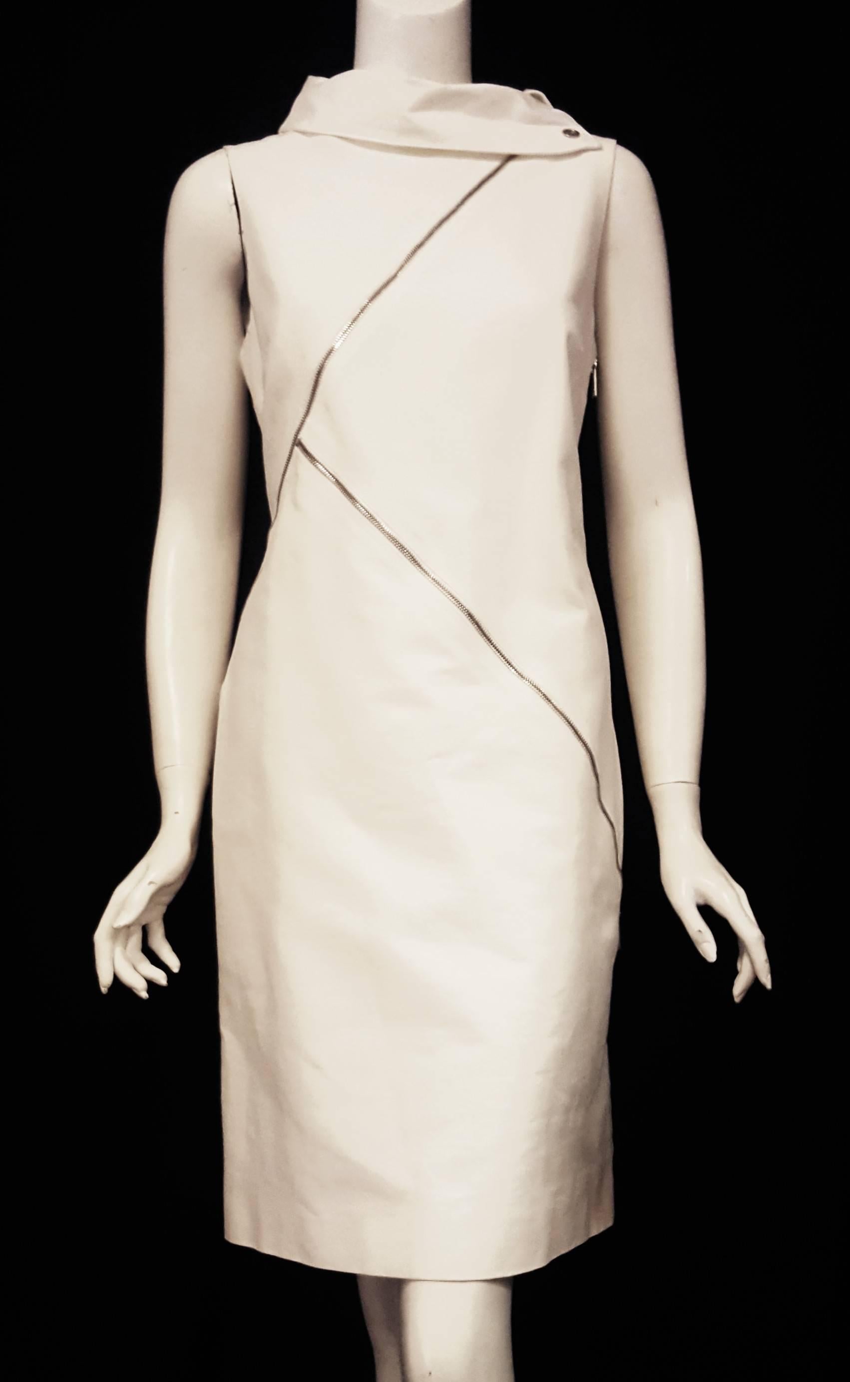 Michael Kors ivory zipper accented sleeveless dress with multi zippers throughout and a round cowl collar with  Michael Kors silver tone button on one side.   The 3 zippers zig zag across the front and side of the dress, two zippers are real