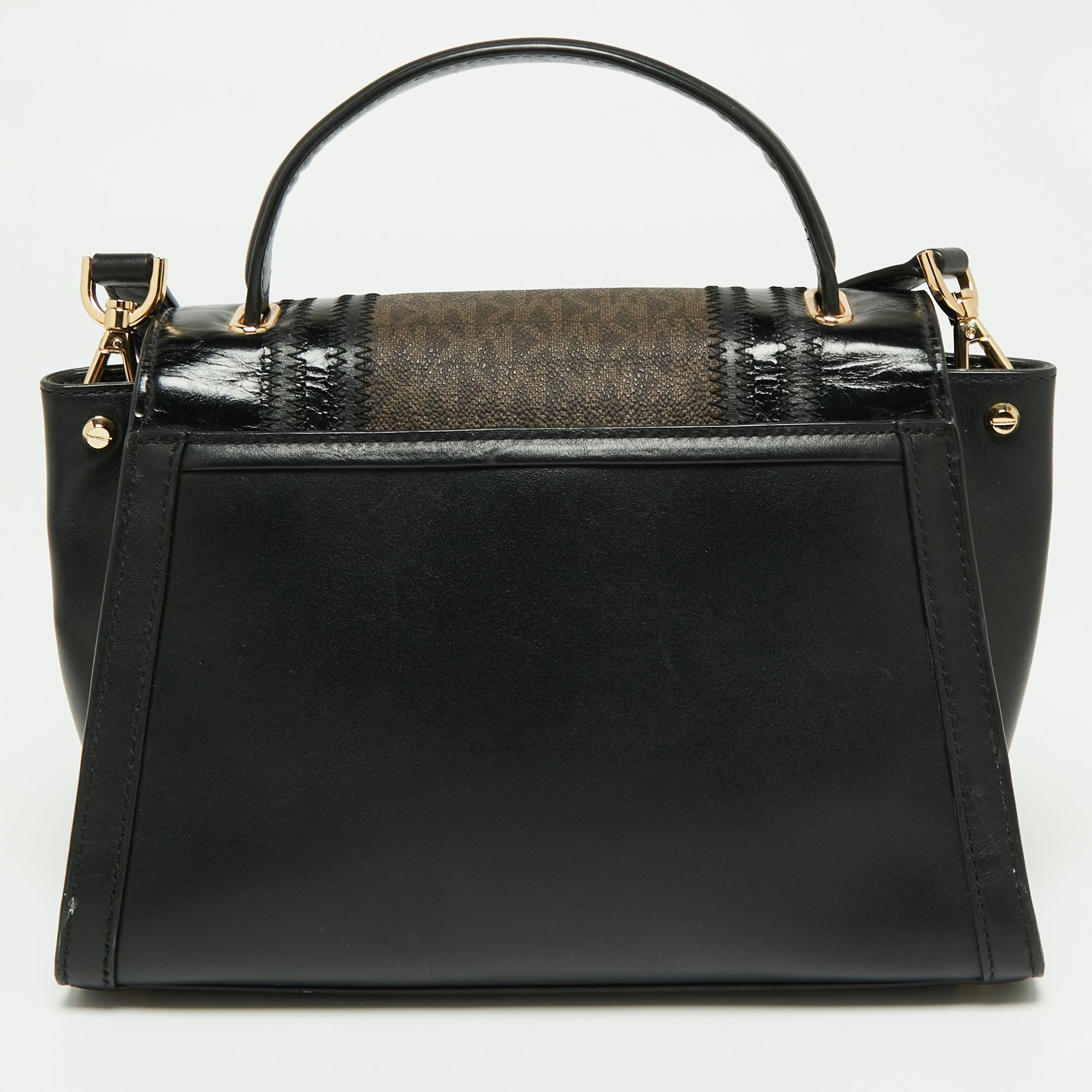 Beautified with gold-tone accents and a structured silhouette, this Michael Kors Whitney bag is an ideal option for your next outing. It comes crafted from the signature coated canvas and leather and exhibits the brand signature on the front, dual