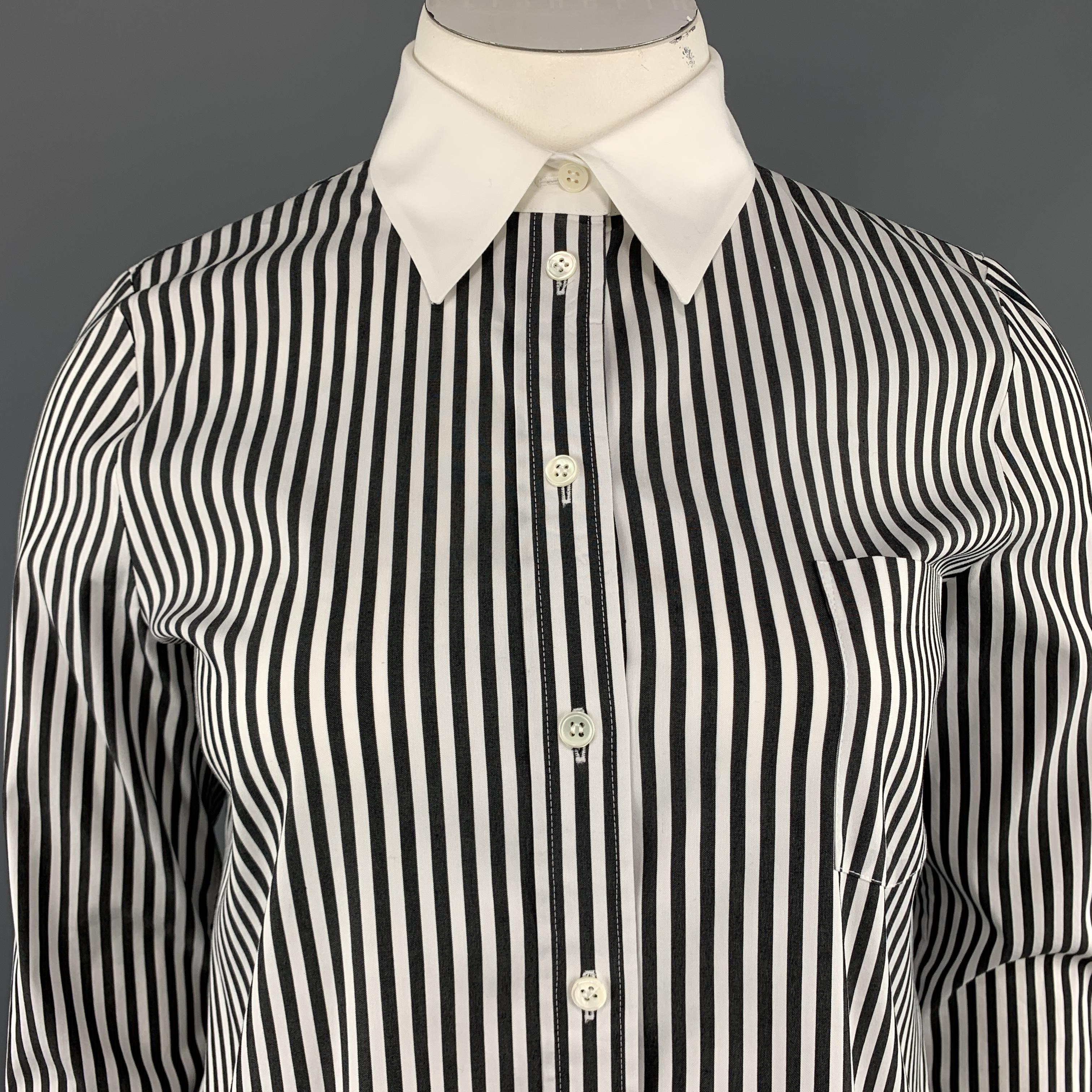 MICHAEL KORS shirt comes in black and white striped stretch cotton with white contrast collar, breast pocket, and French cuff. Made in Italy.
 

Excellent Pre-Owned Condition.
Marked: 12

Measurements:

Shoulder: 16 in.
Bust: 44 in.
Sleeve: 25.5