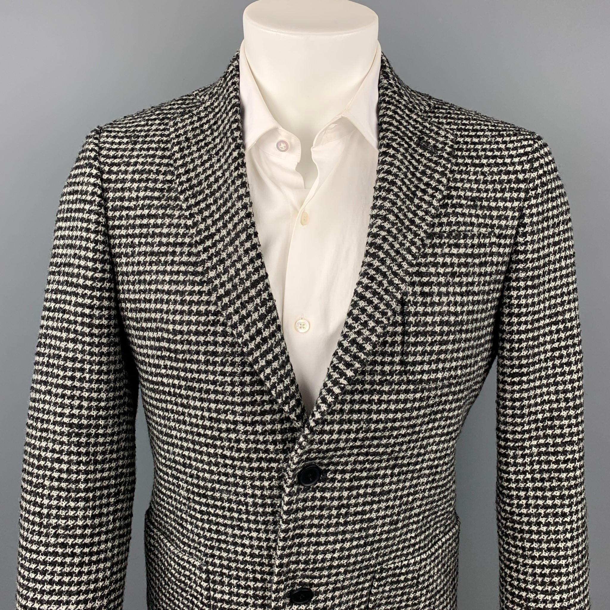 MICHAEL KORS sport coat comes in a black & grey houndstooth wool blend with a half liner featuring a notch lapel, patch pockets, and a two button closure. 

Very Good Pre-Owned Condition.
Marked: 36 / 46 R

Measurements:

Shoulder: 17 in.
Chest: 40