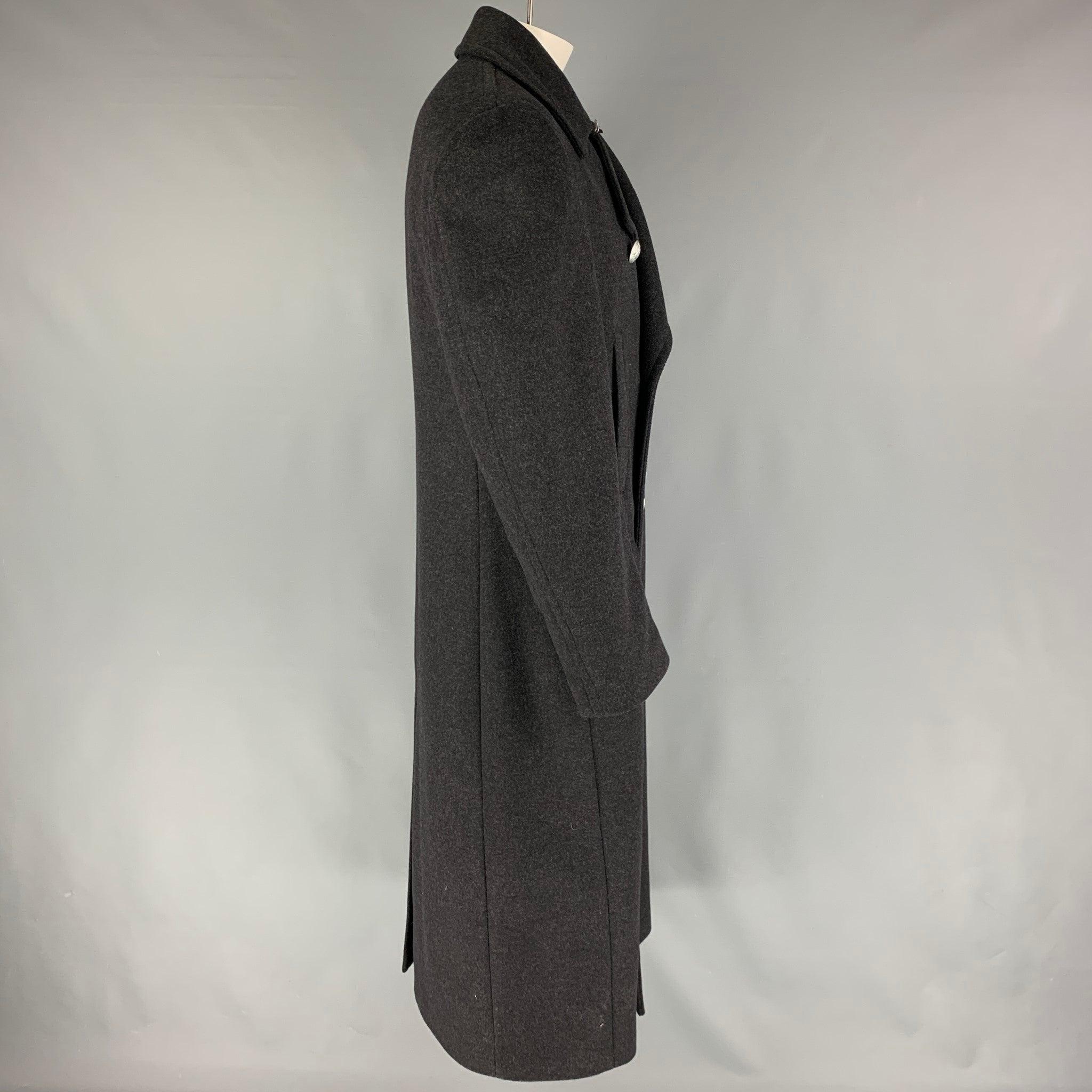 MICHAEL KORS coat comes in a charcoal wool blend featuring a notch lapel, flap pockets, silver tone buttons, single back vent, and a double breasted closure. Made in Italy.
Very Good
Pre-Owned Condition. 

Marked:   38R  

Measurements: 
 
Shoulder: