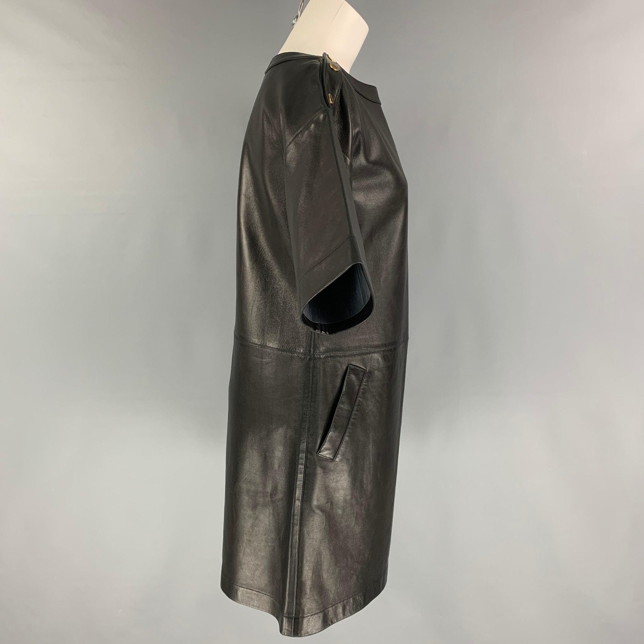 MICHAEL KORS dress comes in a black leather featuring short sleeves, slit pockets, and gold tone shoulder snap buttons. Made in Italy.
Very Good
Pre-Owned Condition. 

Marked:   4 

Measurements: 
 
Shoulder: 21 inches  Bust: 38 inches  Waist: 36
