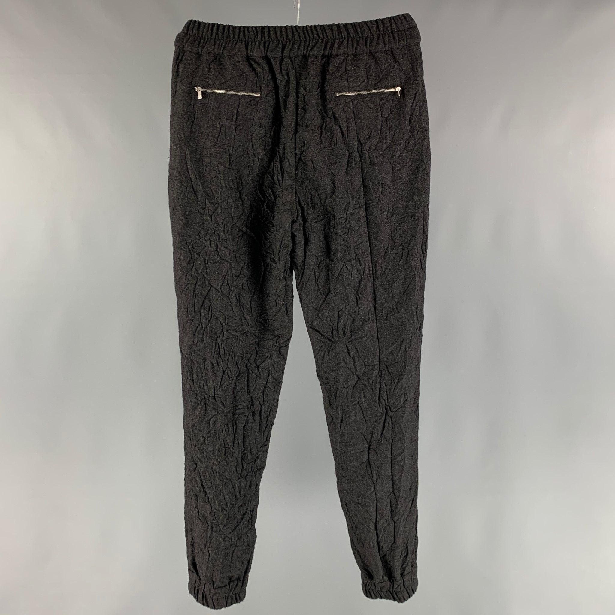 MICHAEL KORS sweatpants comes in a grey virgin wool woven material featuring wrinkle texture, zipper pockets, cuffed legs, and an elastic waistband. Excellent Pre-Owned Condition.  

Marked:   4 

Measurements: 
  Waist: 30 inches Rise: 10.5 inches