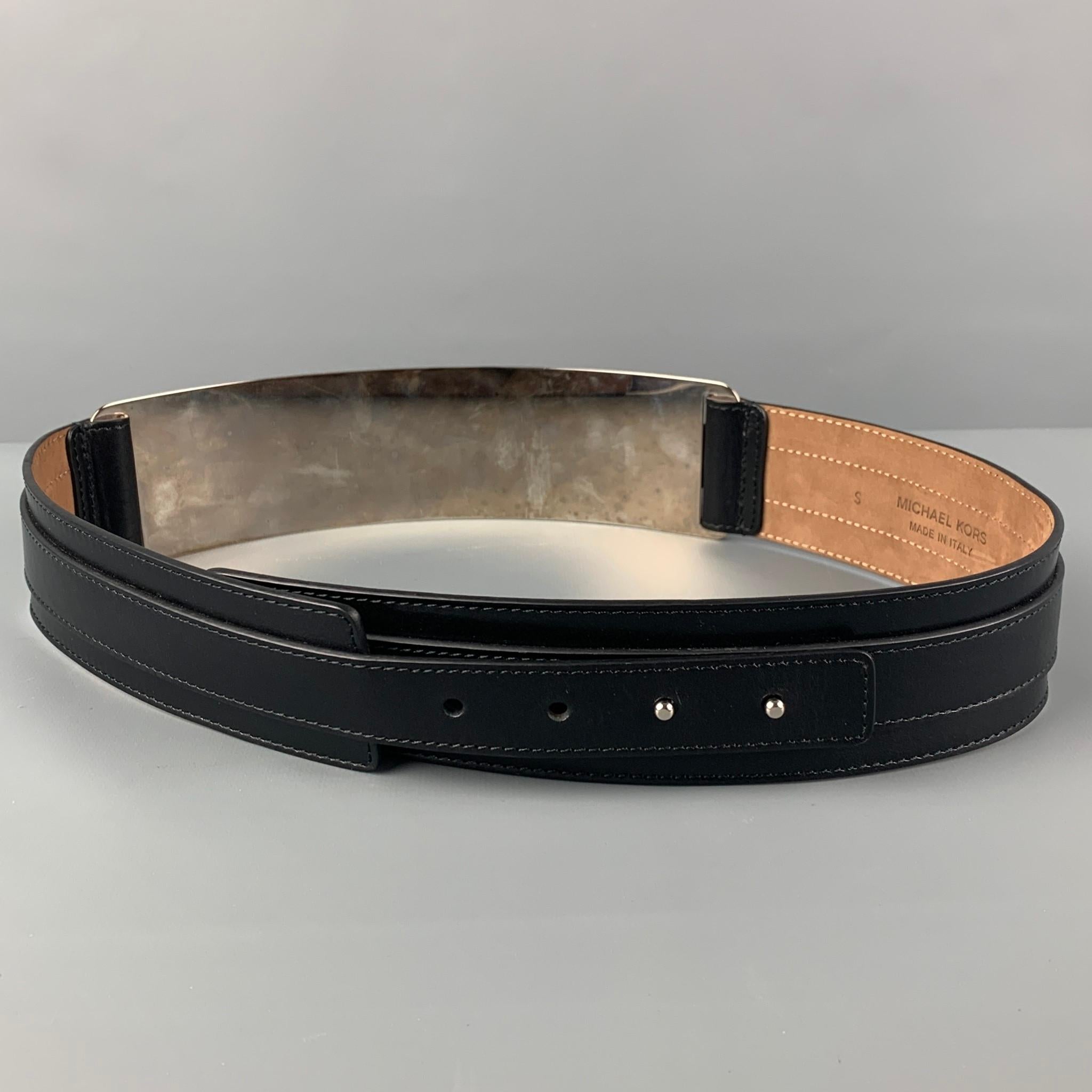 MICHAEL KORS belt comes in a black leather featuring a silver tone metal panel design and a front buckle detail. Made in Italy. 

Good Pre-Owned Condition.
Marked: S
Original Retail Price: $690.00

Length: 36.5 in.
Width: 2 in.
Fits: 33 in. - 36 in. 