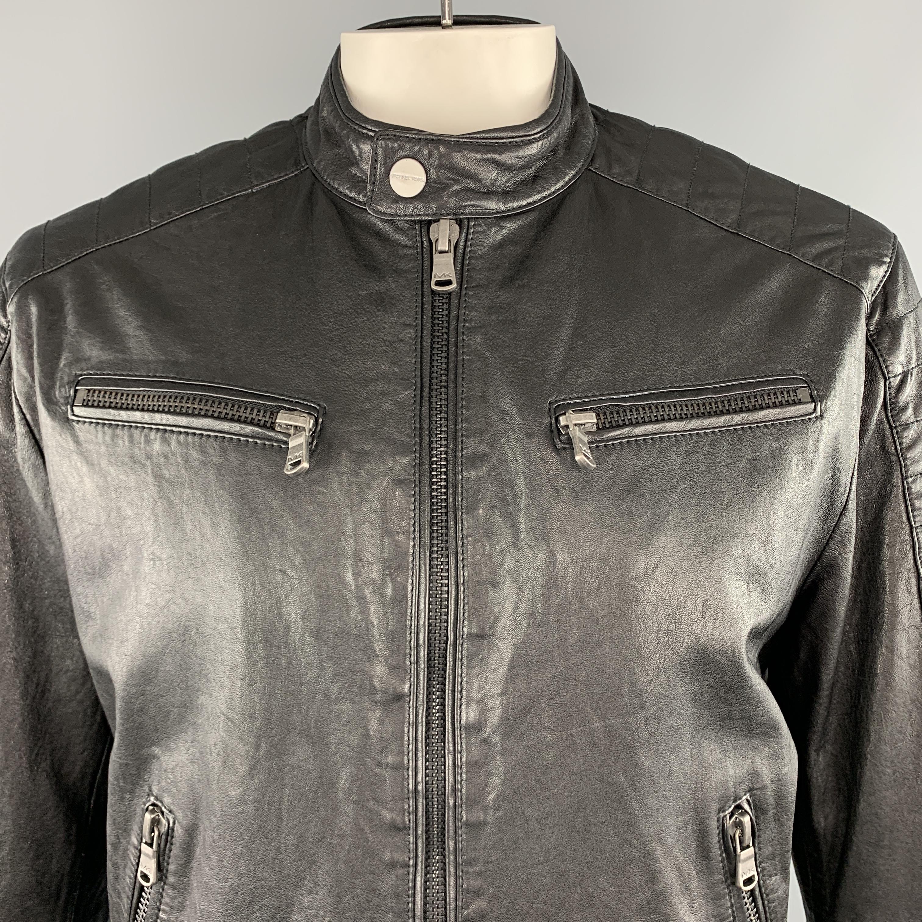 MICHAEL KORS biker jacket comes in black leather with a band snap collar, zip up front, four zip pockets, and quilted patches. 

Excellent Pre-Owned Condition.
Marked: XL

Measurements:

Shoulder: 18 in.
Chest: 48 in.
Sleeve: 26 in.
Length: 28 in.