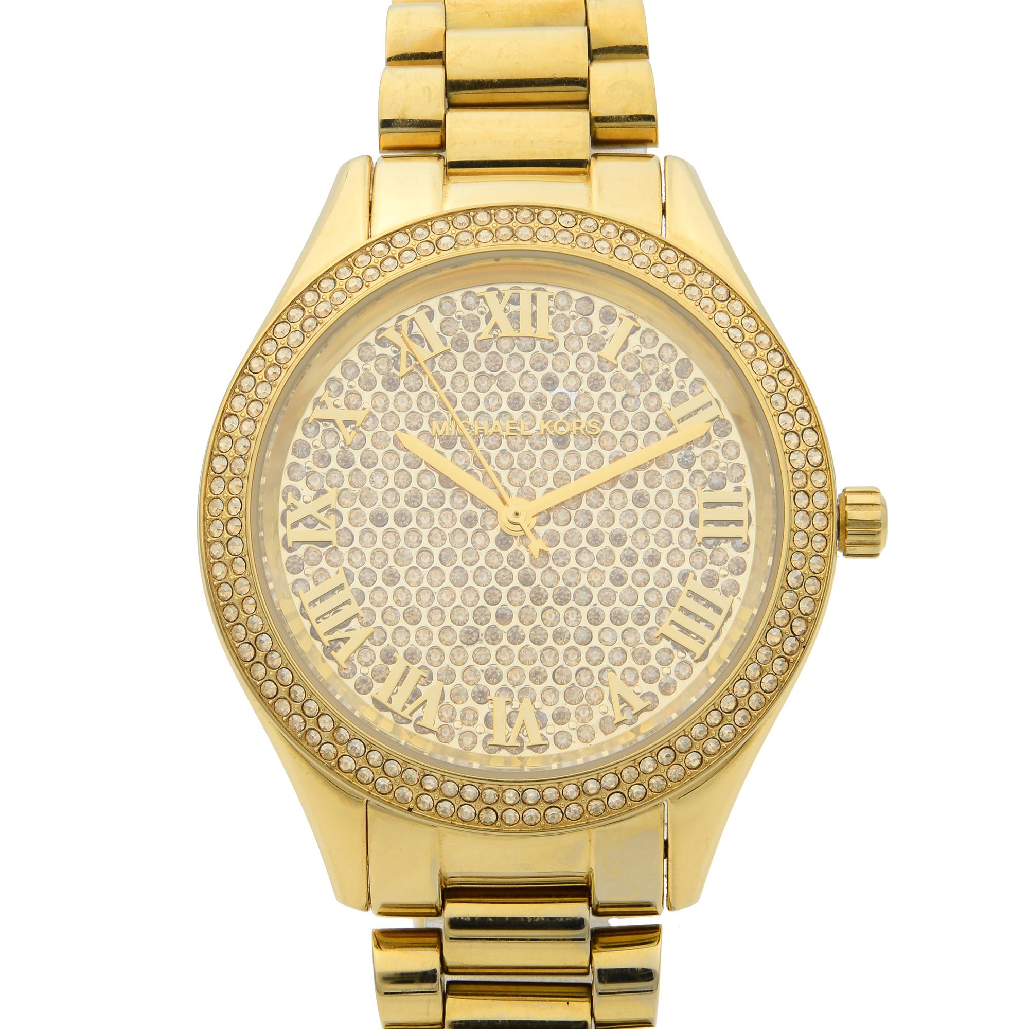 This pre-owned Michael Kors MK3319 Watch is a beautiful women's timepiece that is powered by quartz (battery) movement which is cased in a stainless steel case. It has a round shape face and has hand sticks style markers. It is completed with a