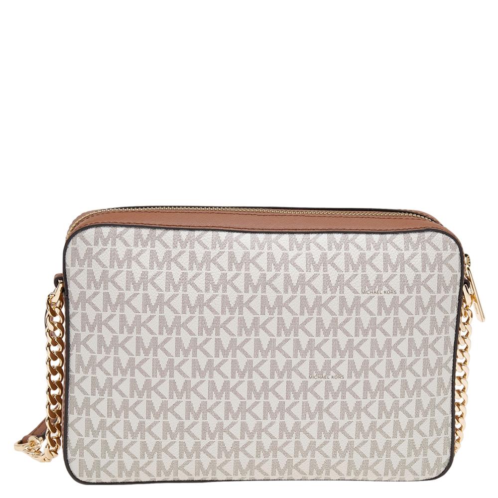 This Michael Kors bag is beautiful in so many ways. From its design to its structure, the bag in signature coated canvas & leather offers charm and function. It flaunts a shoulder strap for you to swing and a fabric interior to hold all your