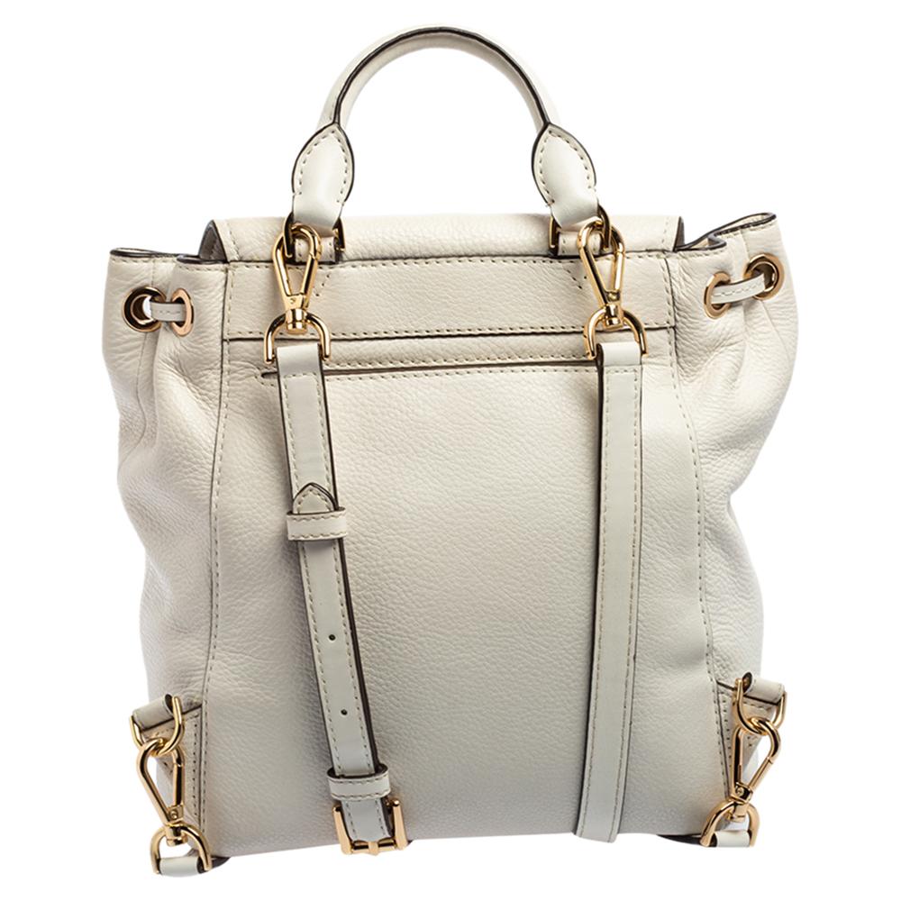 To accompany all your casual outings in the most fashionable way, Michael Kors brings you this backpack that boasts fabulous style and outstanding details. It flaunts a white exterior with a flap, carrying embellishments. The bag has a top handle