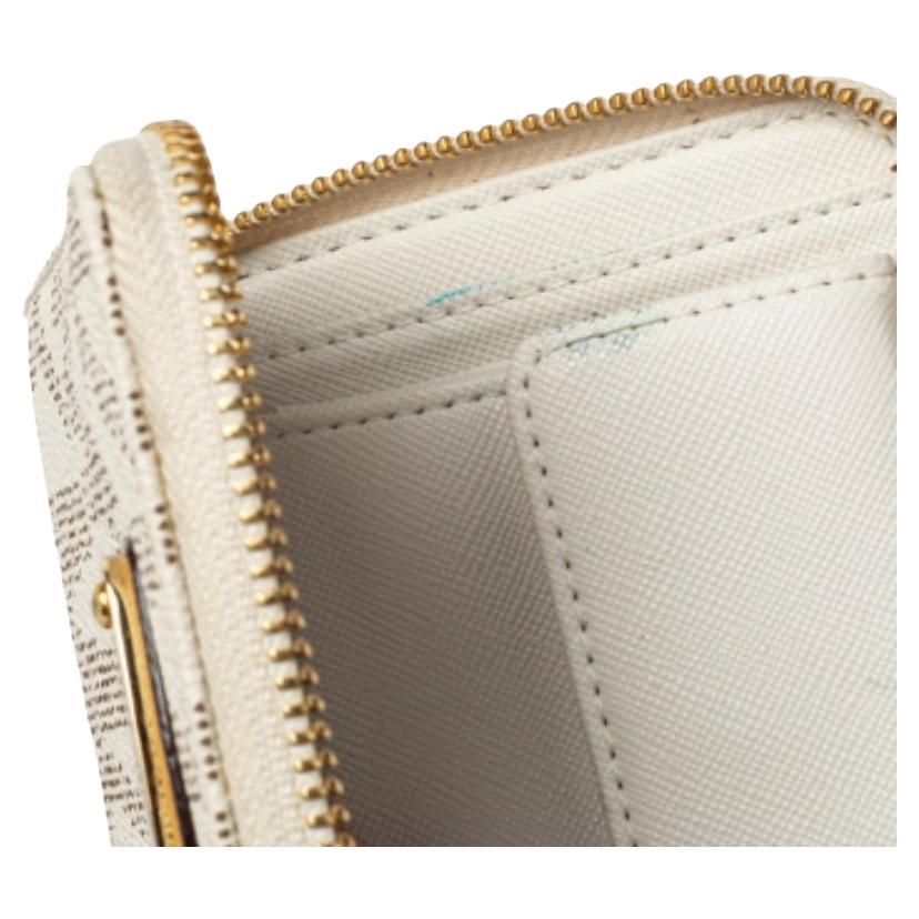 This wallet is a lovely creation from the house of Michael Kors. Crafted from signature canvas, the wallet is adorned with a logo plaque and secured with a zip-around closure.