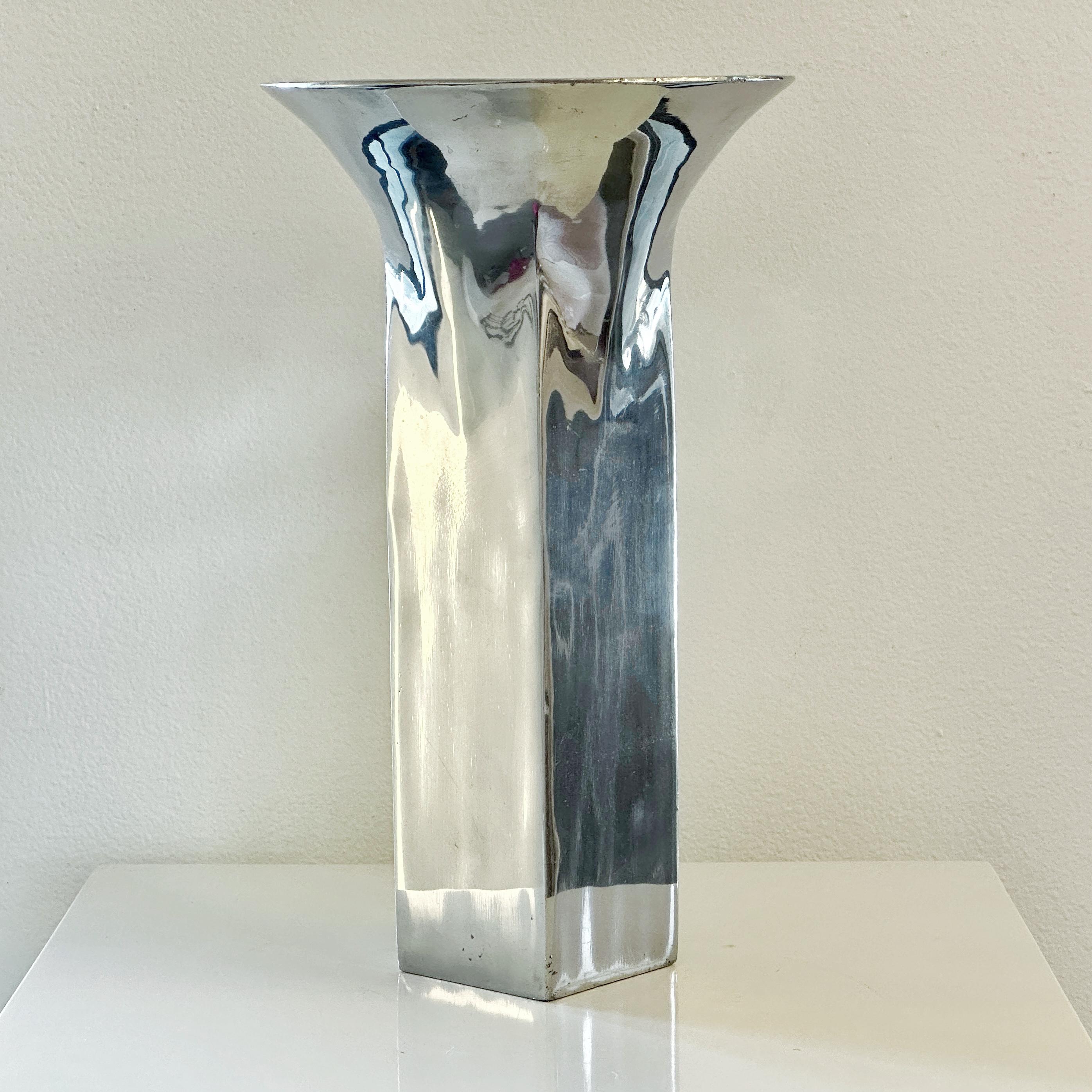 Measures 12-3/4” high, 7-1/2” wide at the mouth, 2-7/8” wide at the base.

Stamped on base
METAAL
Grainware c 1992
Michael Lax Design 
ML-4012

There are some light scuffs and scratches especially toward the base, patina to finish. See images for