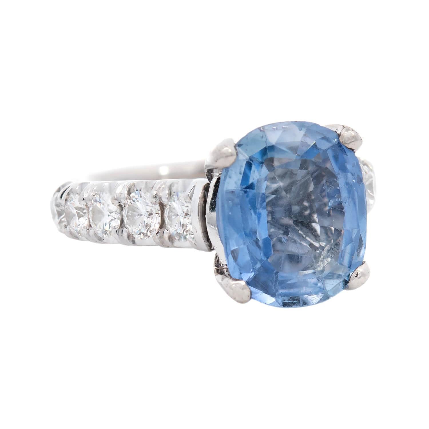 A beautiful sapphire and diamond ring from legendary jeweler Michael M! Crafted in 18k white gold, this substantial ring features a central 3.67ct oval cut sapphire. The sapphire rests within a four-prong setting, and displays a magnificent