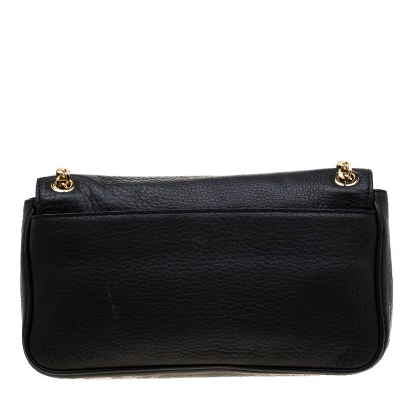 This chic bag in black is from Michael Michael Kors. The bag is crafted from leather and features a flap that opens up to a fabric-lined interior sized to fit your daily essentials. The bag is equipped with a shoulder chain for you to swing