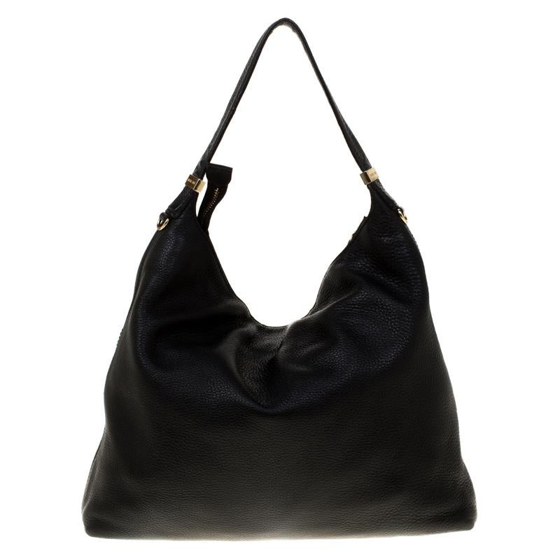 Swap that regular everyday bag with this charming creation from the house of Michael Kors. Crafted from leather, it comes fitted with a leather top handle and a tassel accent on the zipper pull. The spacious fabric lined interior can hold all your
