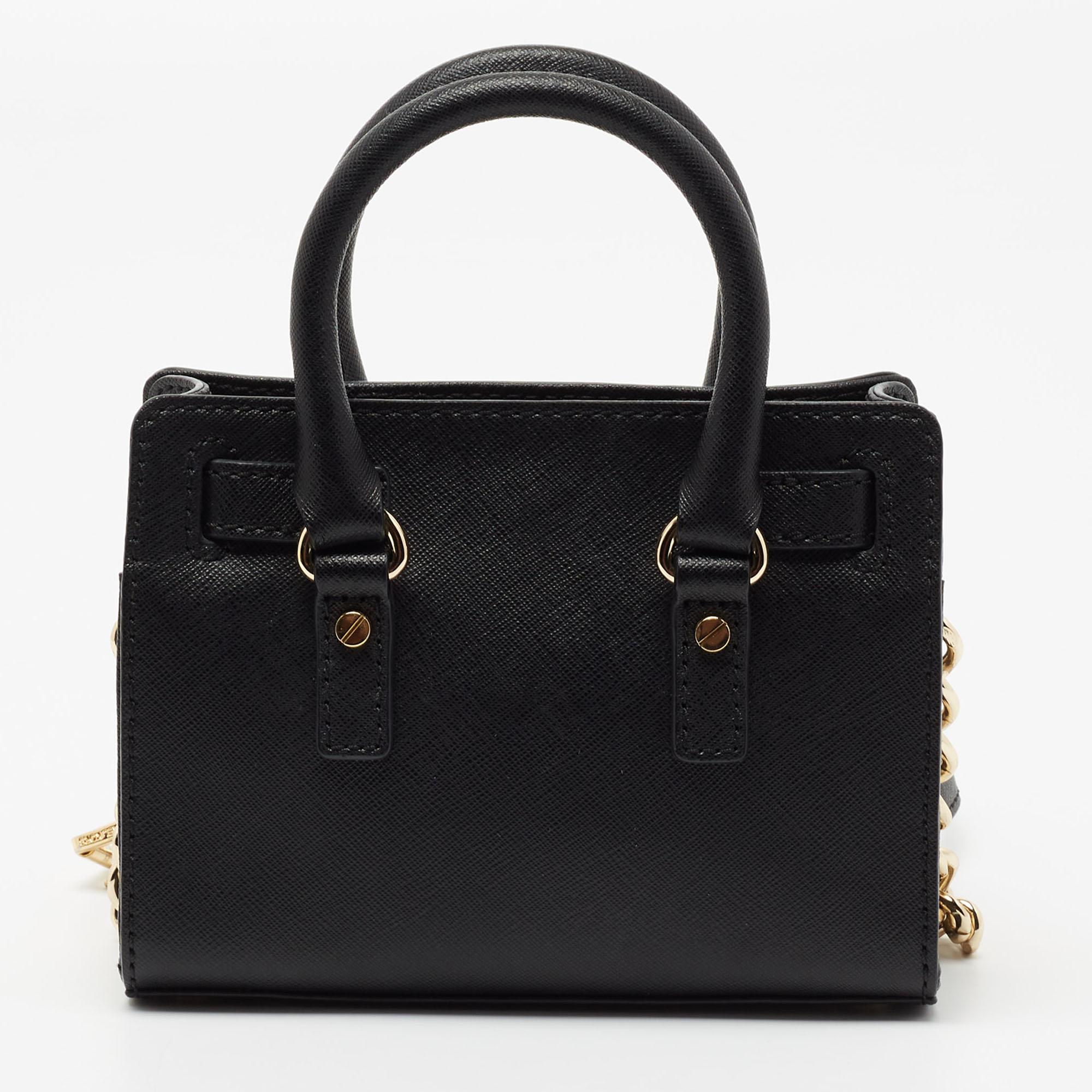 The dual handles and the shoulder strap makes this MICHAEL Michael Kors Hamilton bag a practical styling choice. Constructed from leather, the gold-tone accents makes it undeniably chic, and it features a branded lock closure on the front. The