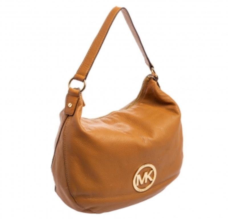 This beautifully stitched leather hobo is by MICHAEL Michael Kors. With a capacious fabric-lined interior, front logo detail, comfortable handle, and a fine finish, this hobo is bound to offer style and practical ease.
