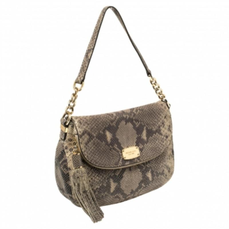 Deserving a place in your closet is this crossbody bag from MICHAEL Michael Kors! The bag is crafted from python-embossed leather and features a shoulder handle and a detachable strap. It has the brand detail on the front and opens to a spacious