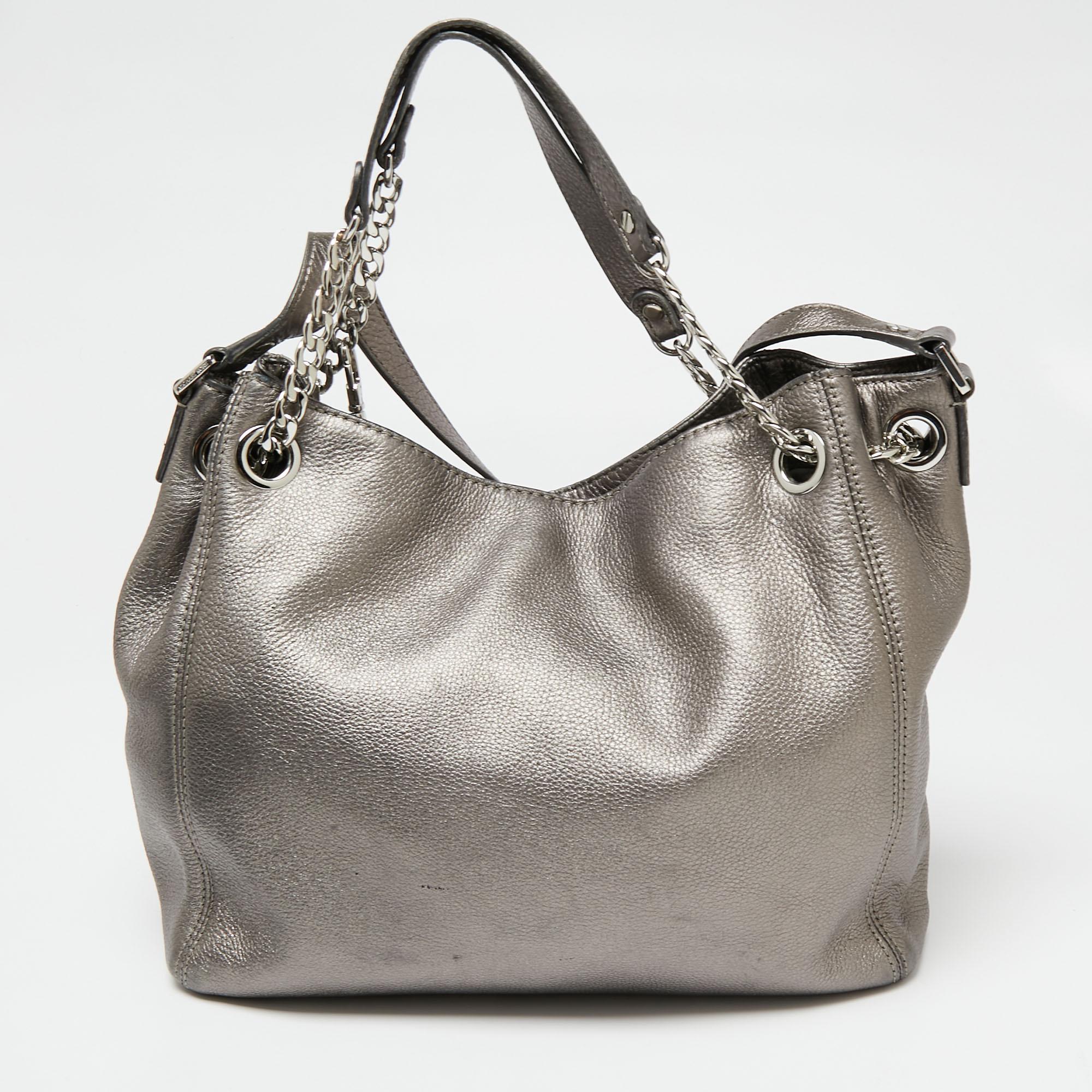 Diese Tasche von MICHAEL Michael Kors ist ideal für den täglichen Gebrauch. Sie ist aus grauem Metallic-Leder gefertigt und verfügt über zwei Griffe, silberfarbene Beschläge und ein stoffgefüttertes Innenleben. Diese Tasche lässt Sie stilvoll