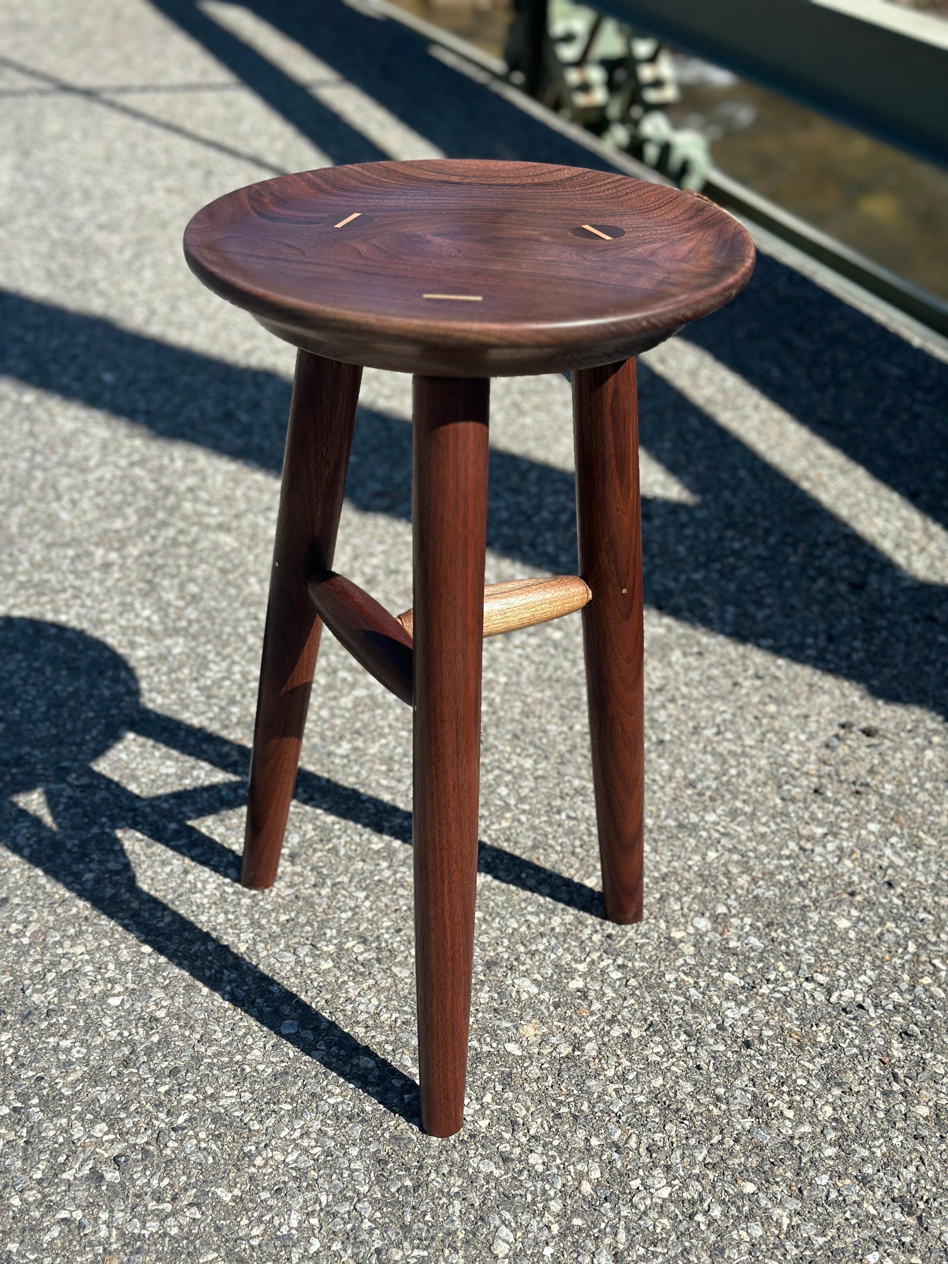 American black walnut accented with brass and maple.
Signed and dated to underside 
