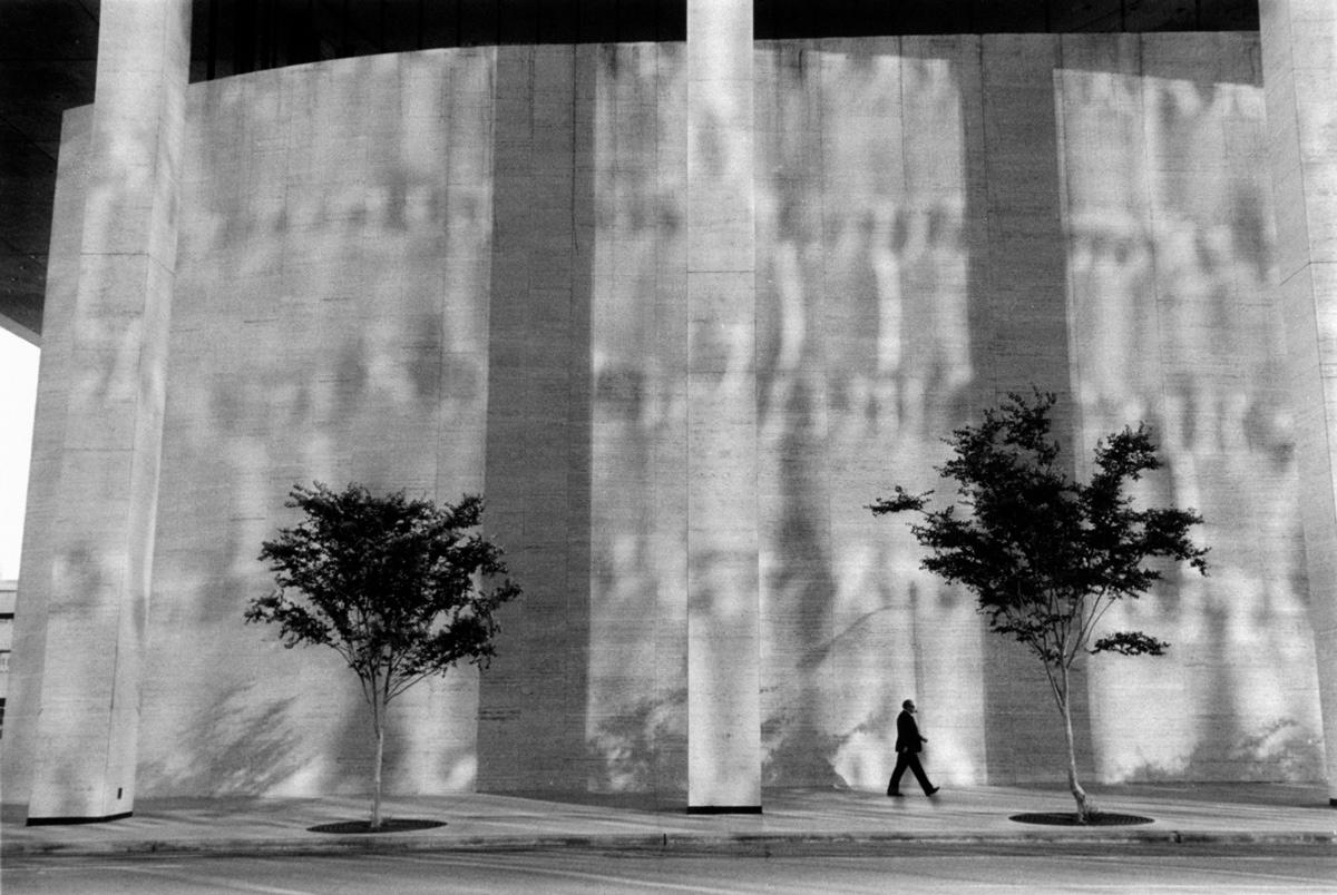 Michael Ormerod Black and White Photograph - Man Walking in Front of Building, Houston - Black and white, Street photography