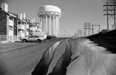 Water Trails Down Empty Street in Front of Water Tower - Black and White Print