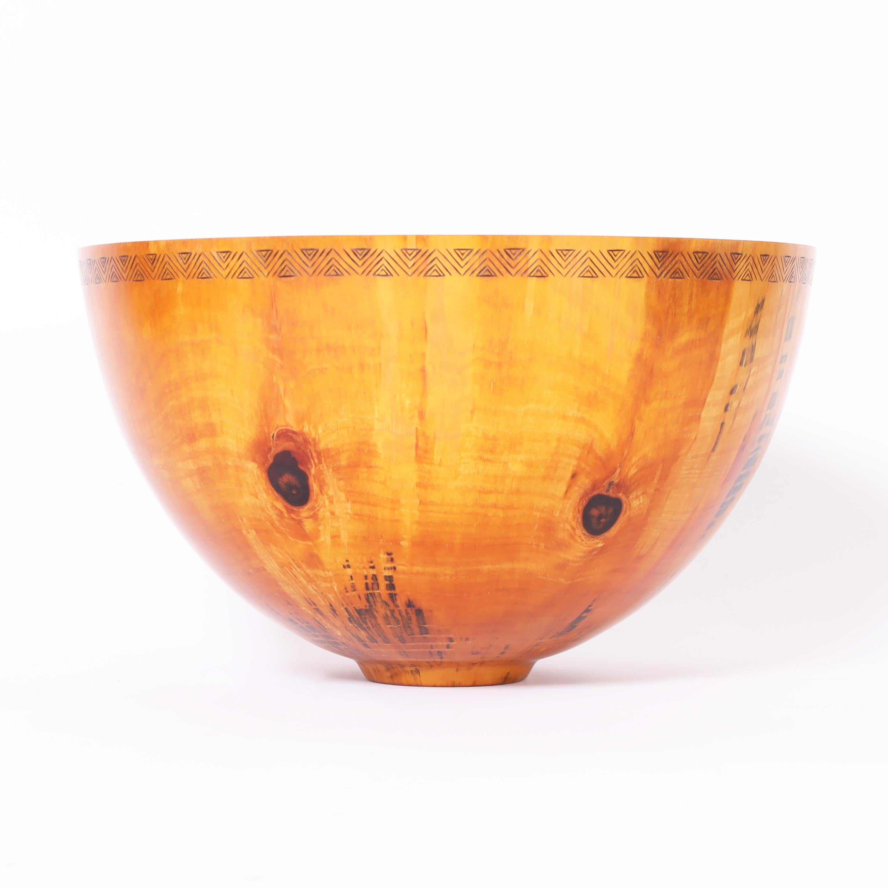 Impressive large scale bowl crafted in Norfolk Pine, a hard wood particularly suited for turning. Michael Patrick Smith is an American artist working in Hawaii not only works the lathe but creates the burned designs or pyrography. 