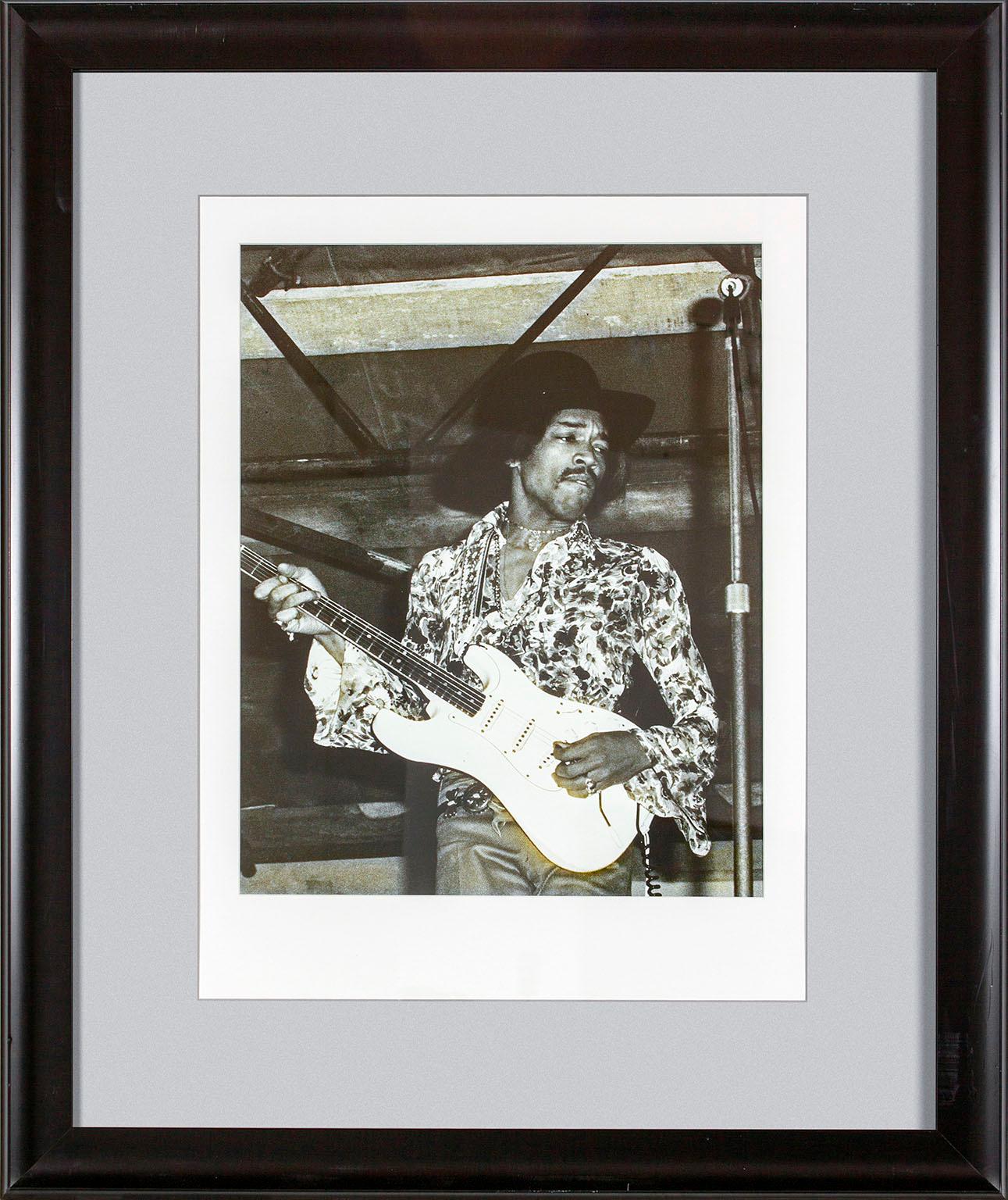 "Jimi Hendrix" framed black and white photograph by Michael Putland of Jimi Hendrix at the July 6, 1968, Woburn Music Festival in England.  Image size: 19 1/2 x 15 1/4 inches. This photo was previously displayed in a guest room of the original Hard
