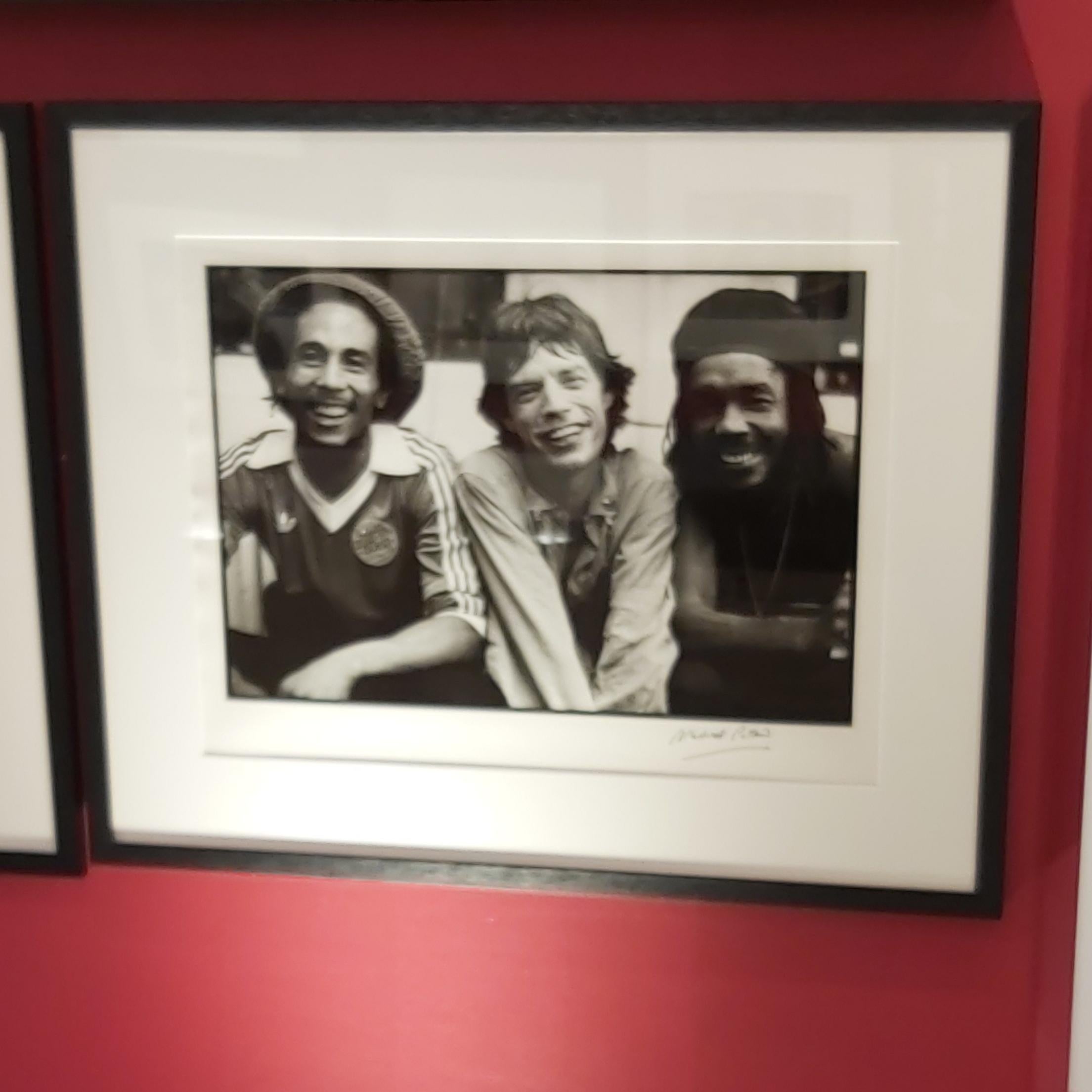 Bob, Mick and Pete, by Michael Putland, 1978. Signed Edition.

Bob Marley, Mick Jagger and Peter Tosh backstage after the Rolling Stones concert at the Palladium Theatre, New York, 1978.

Silver Gelatin Fibre darkroom print.
Framed in b lack solid