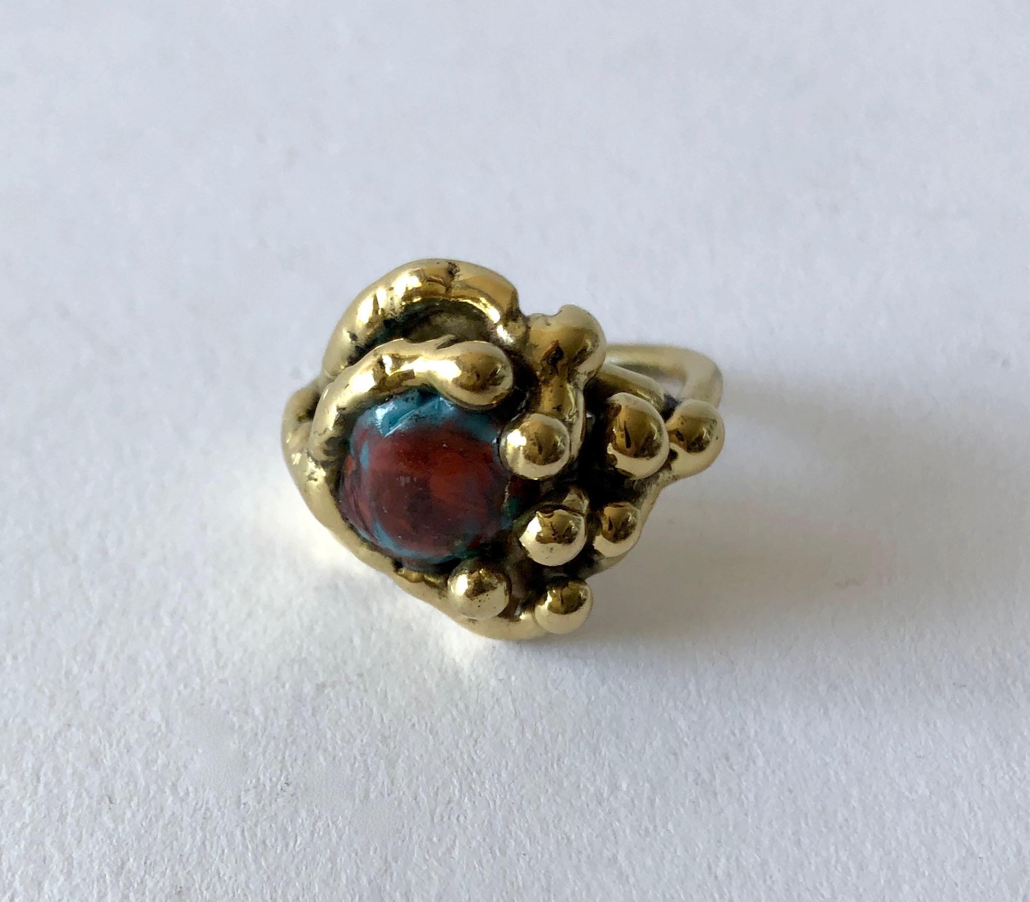 Handmade bronze ring with fused glass stone created by artist and sculptor Michael Schwade of West Fork, Arkansas.  Ring is a finger size 9 and is unsigned.  suitable for a man or woman. In very good condition and unsigned.

I have more great rings