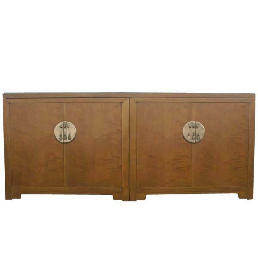 Four Door Credenza Buffet by Baker Furniture 
Far East Collection Credenza 
1960s Design
 
 
Baker mark. 
Features:
(2) Bureaus Connected by A Single Storage Unit
(2) Opposing Cabinets with Interior Shelves
(2) Opposing Cabinets with (1)