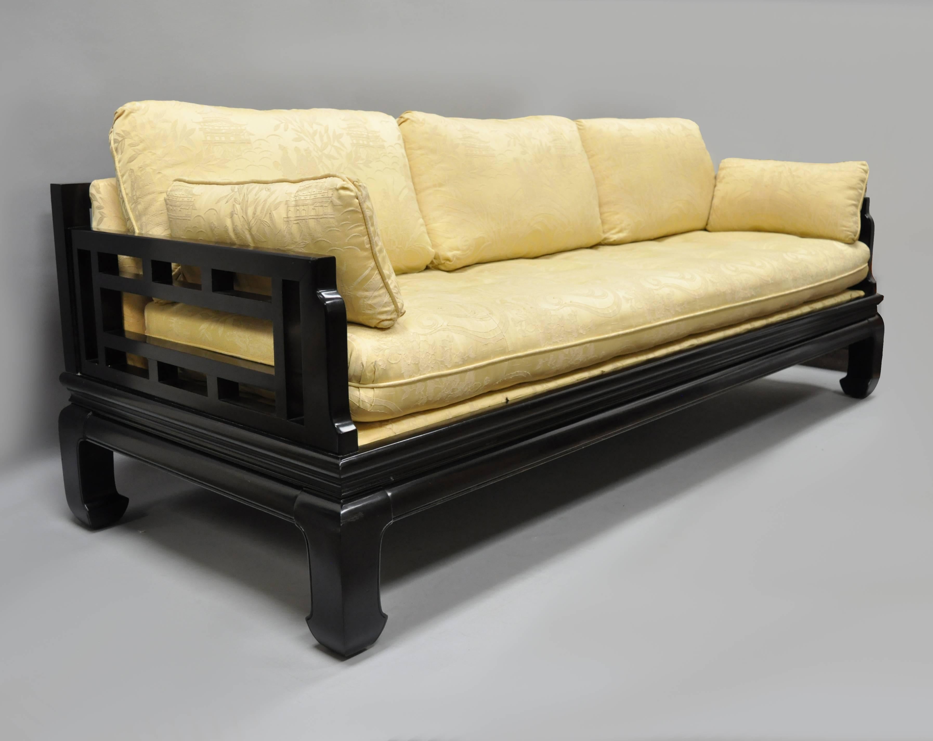 Michael Taylor for Baker ebonized oriental inspired sofa with Lattice Fretwork Back in the James Mont Style. Item features a heavy solid wood frame, fretwork design back and arms, Ming style curved legs, loose cushions, and very impressive form.