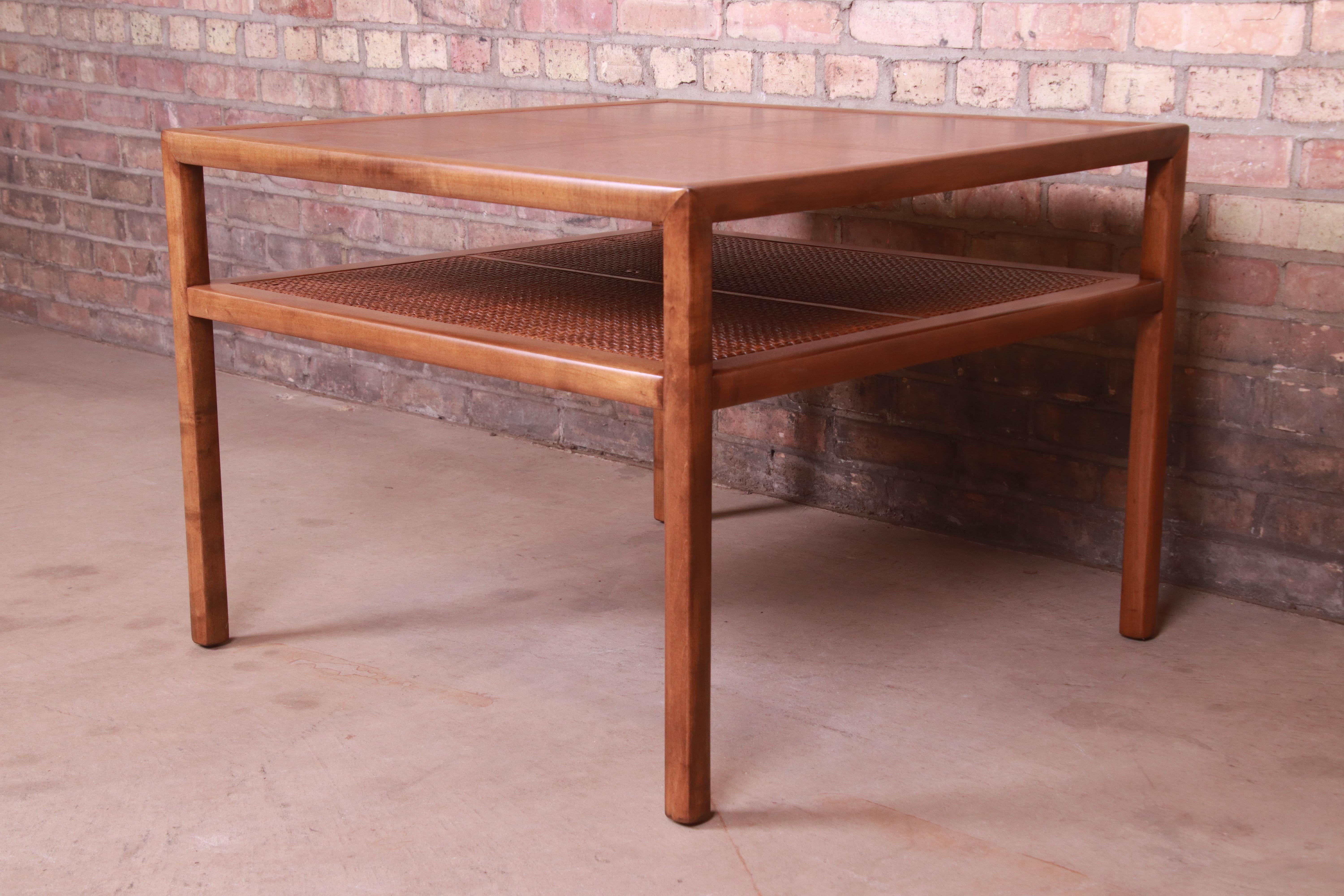 A gorgeous Mid-Century Modern two-tier tea table or coffee table

By Michael Taylor for Baker Furniture

USA, Circa 1950s

Cherry wood, with cane shelf.

Measures: 30