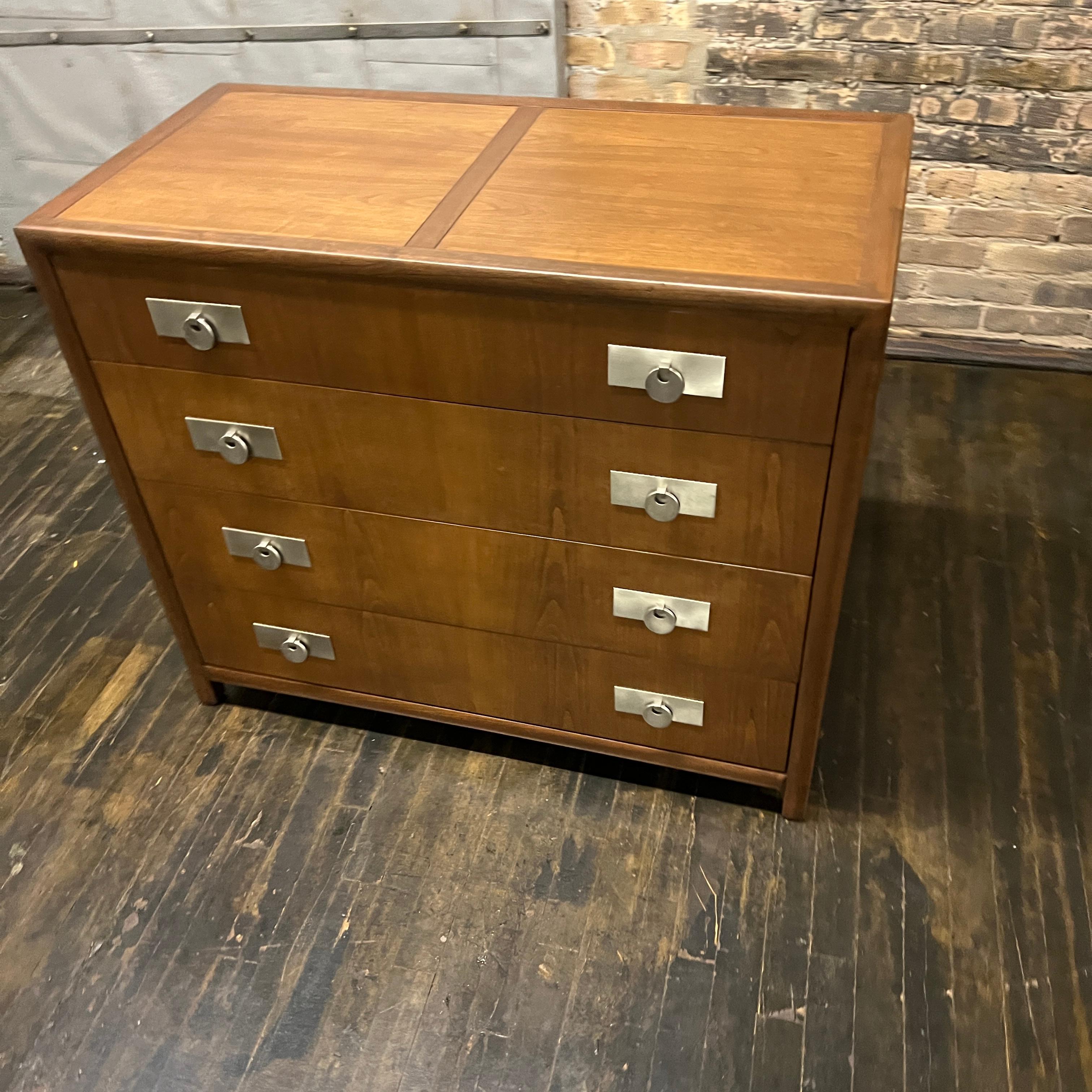Beautiful four drawer dressers by Michael Taylor for Baker, from his New World Collection. This lovely chest of drawers has been expertly restored and features a satin finish.  The wood grain on this piece is amazing.  The drawers are spacious (top