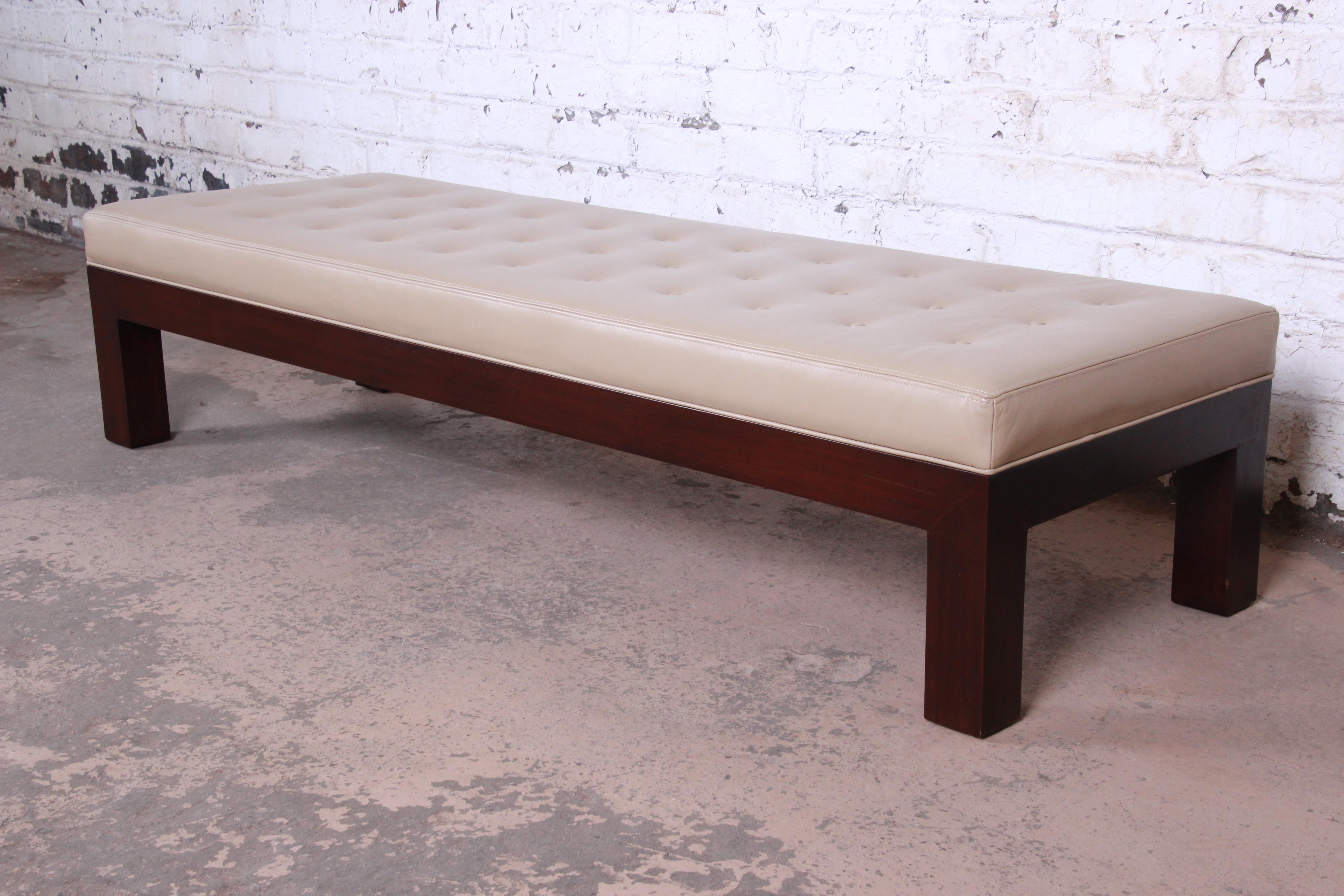 A rare and exceptional Mid-Century Modern Parsons bench designed by Michael Taylor for Baker Furniture. The bench features a gorgeous mahogany frame and legs and sleek, Minimalist mid-century design. Recently reupholstered in high-end tan aniline
