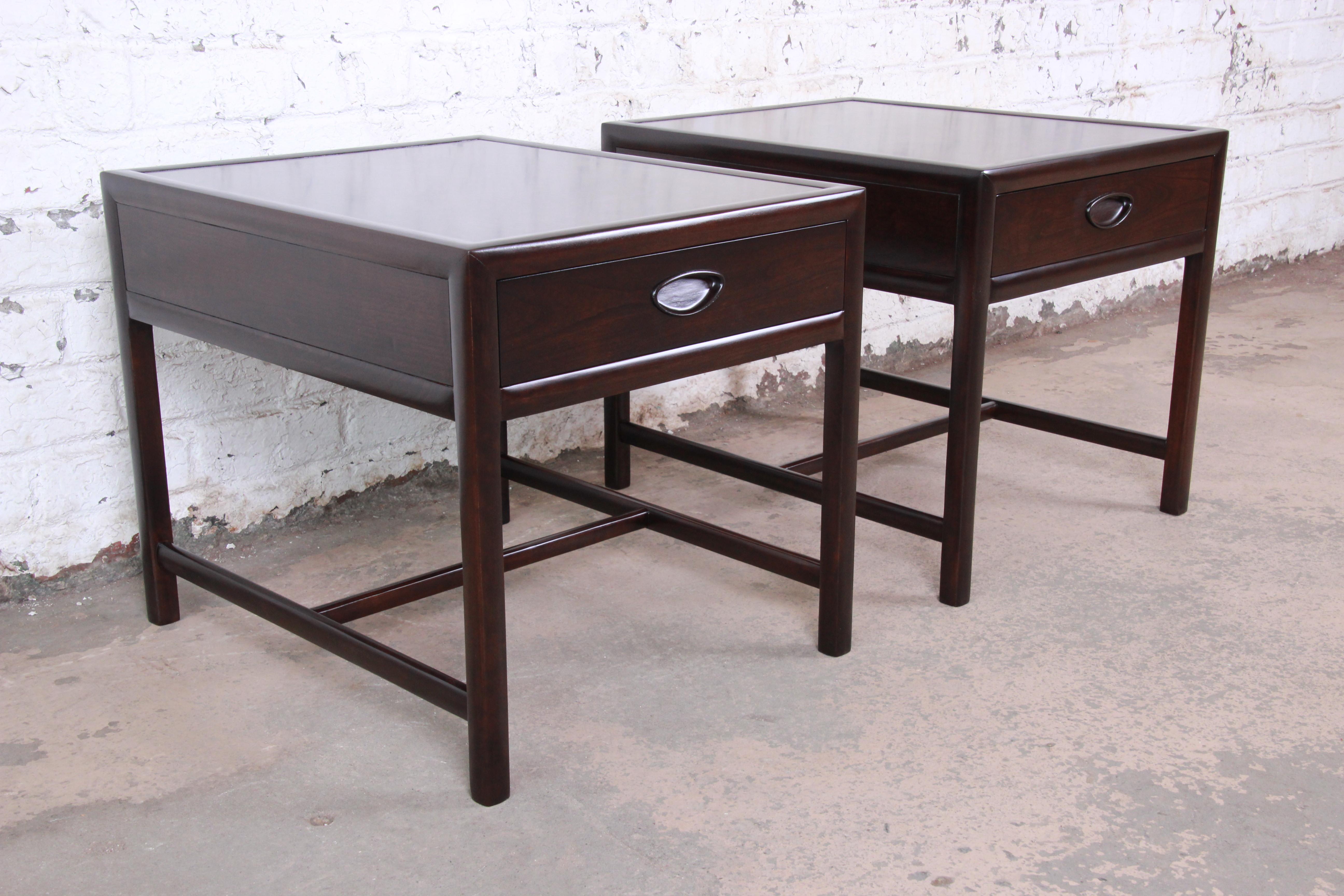 An exceptional pair of Mid-Century Modern dark cherry nightstands

Designed by Michael Taylor for his 