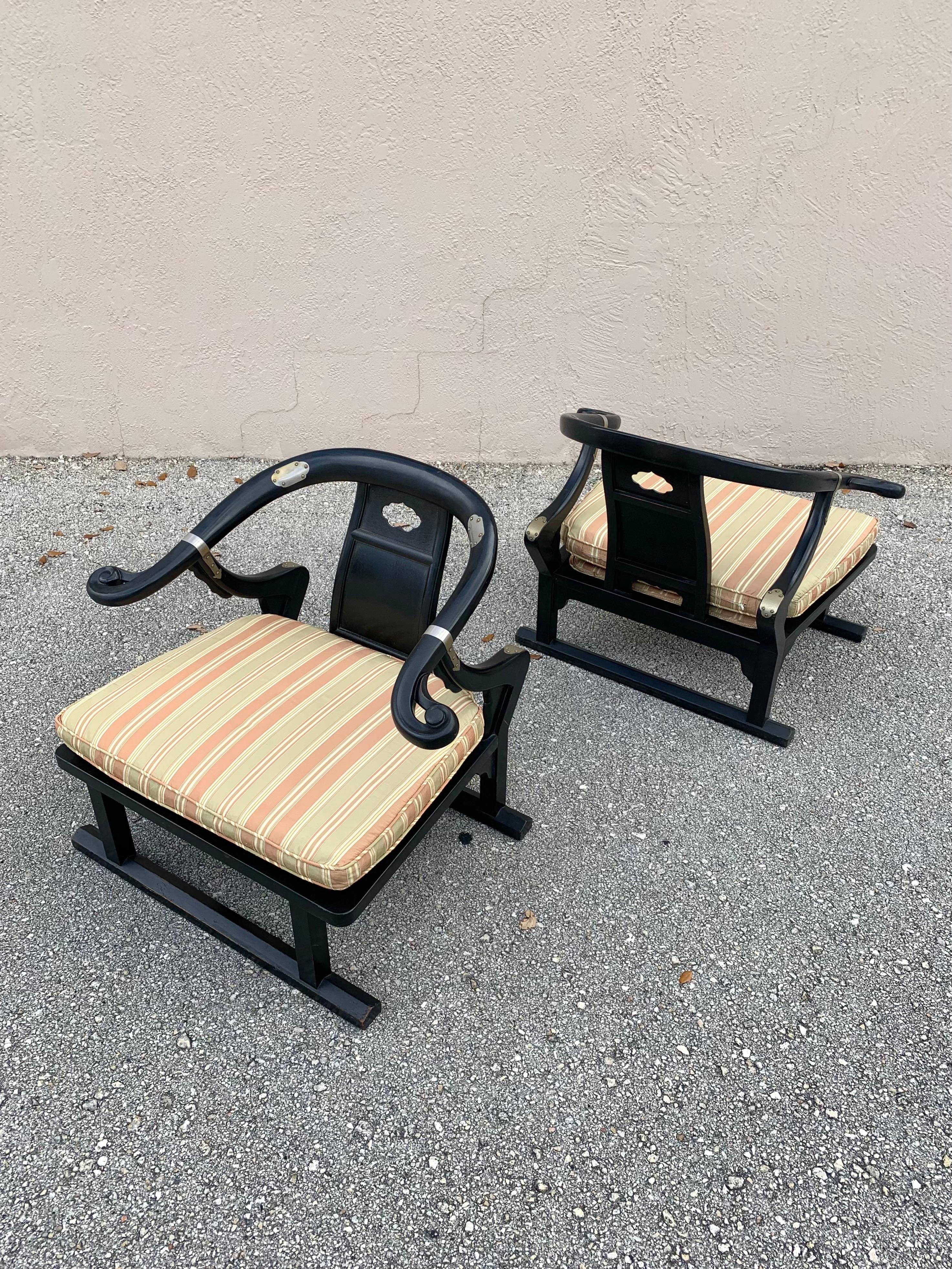 Pair of lounge chairs designed by Michael Taylor. From his Far East collection for Baker Furniture. Model 2510. 

Lacquered walnut frames with steel accents. Horseshoe back with a sled base. Wonderful patina from brass fading on accents and some