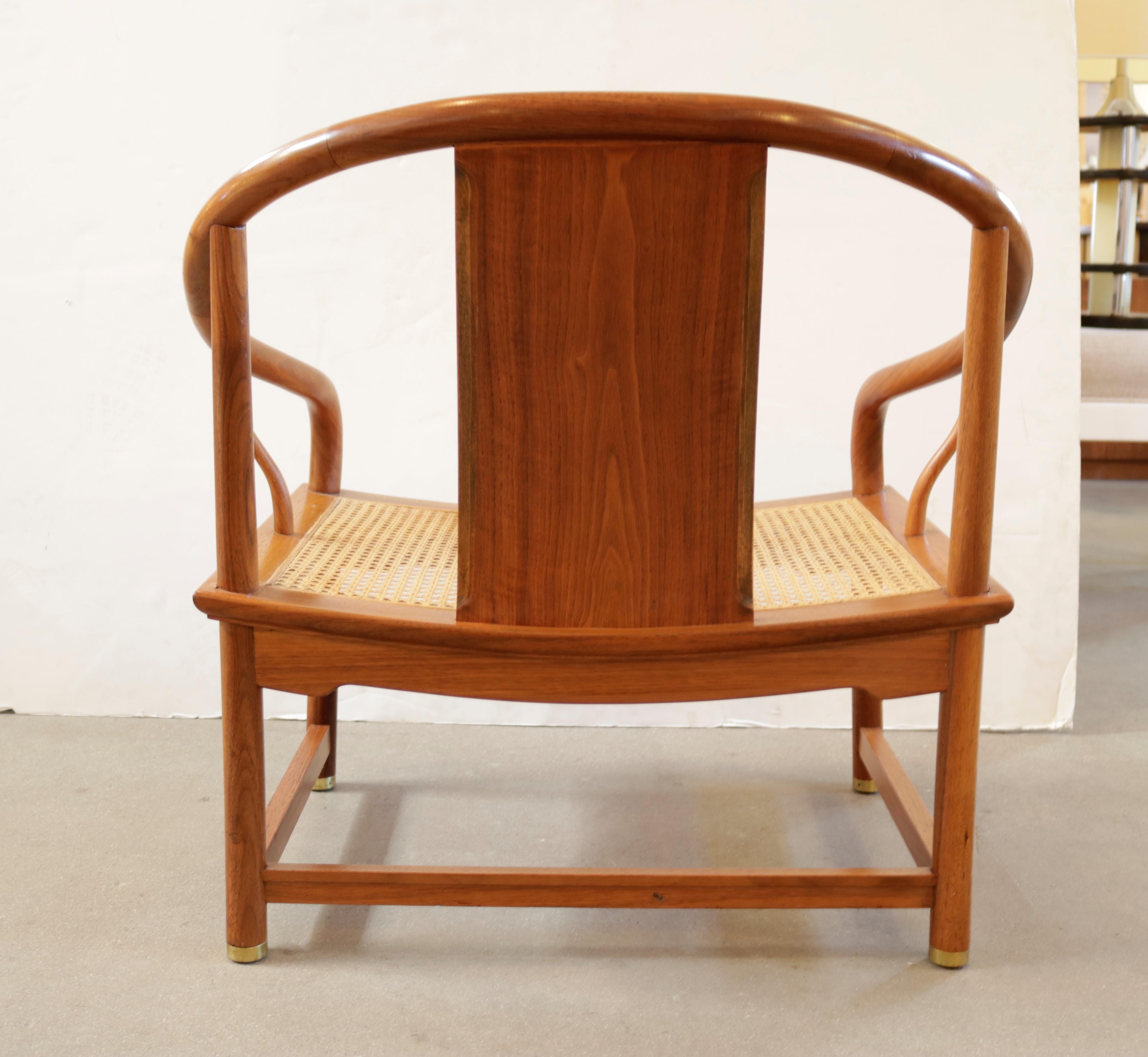 Horseshoe shape caned chair made of blond mahogany by designer Michael Taylor's for Baker Furniture. 
The chair retains the original Baker label.

Michael Taylor was an American designer best known for creating the “California Look” of interior