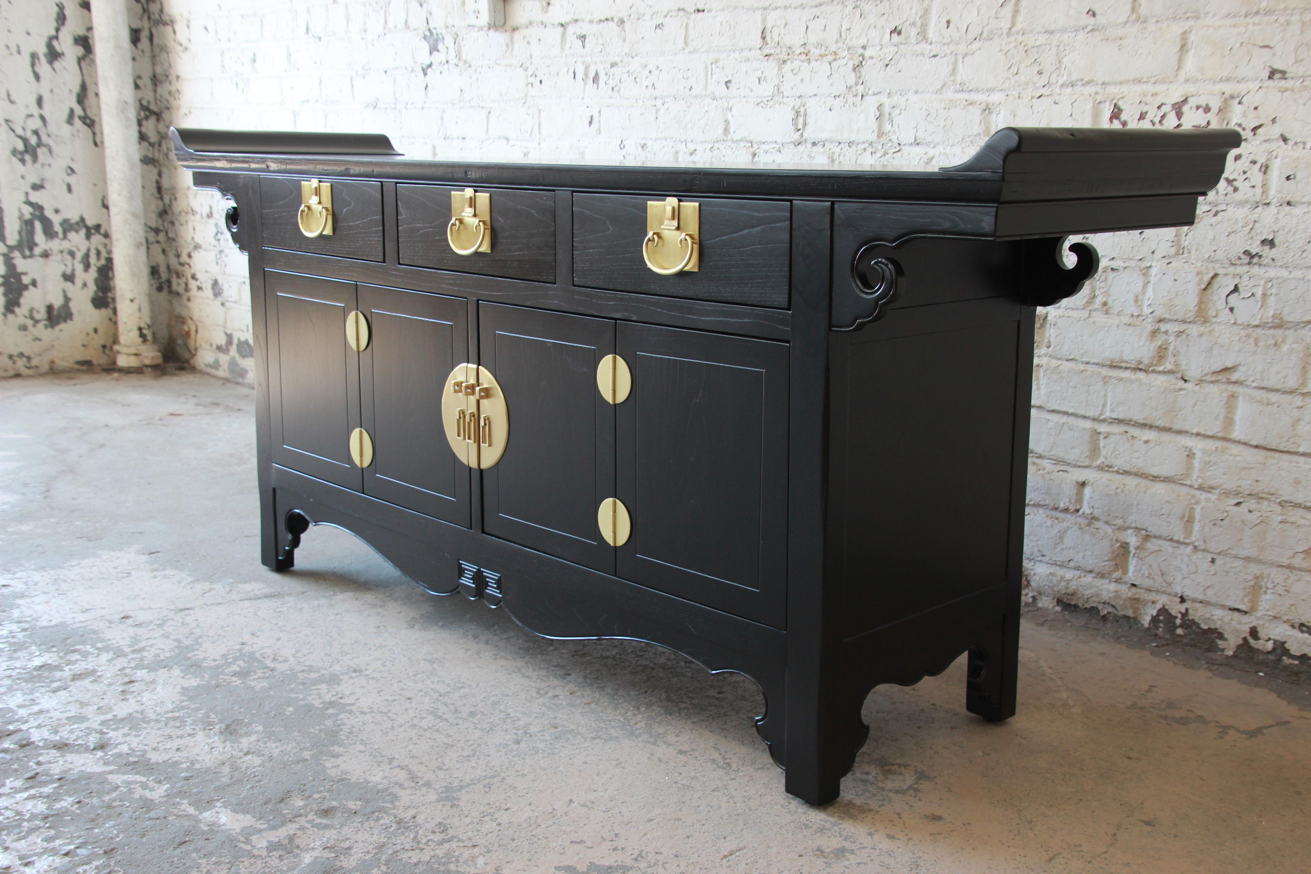 Offering a gorgeous black lacquered chinoiserie sideboard credenza from the Far East collection by Michael Taylor for Baker Furniture. The sideboard features a beautiful Asian design and original brass hardware. It offers ample room for storage,