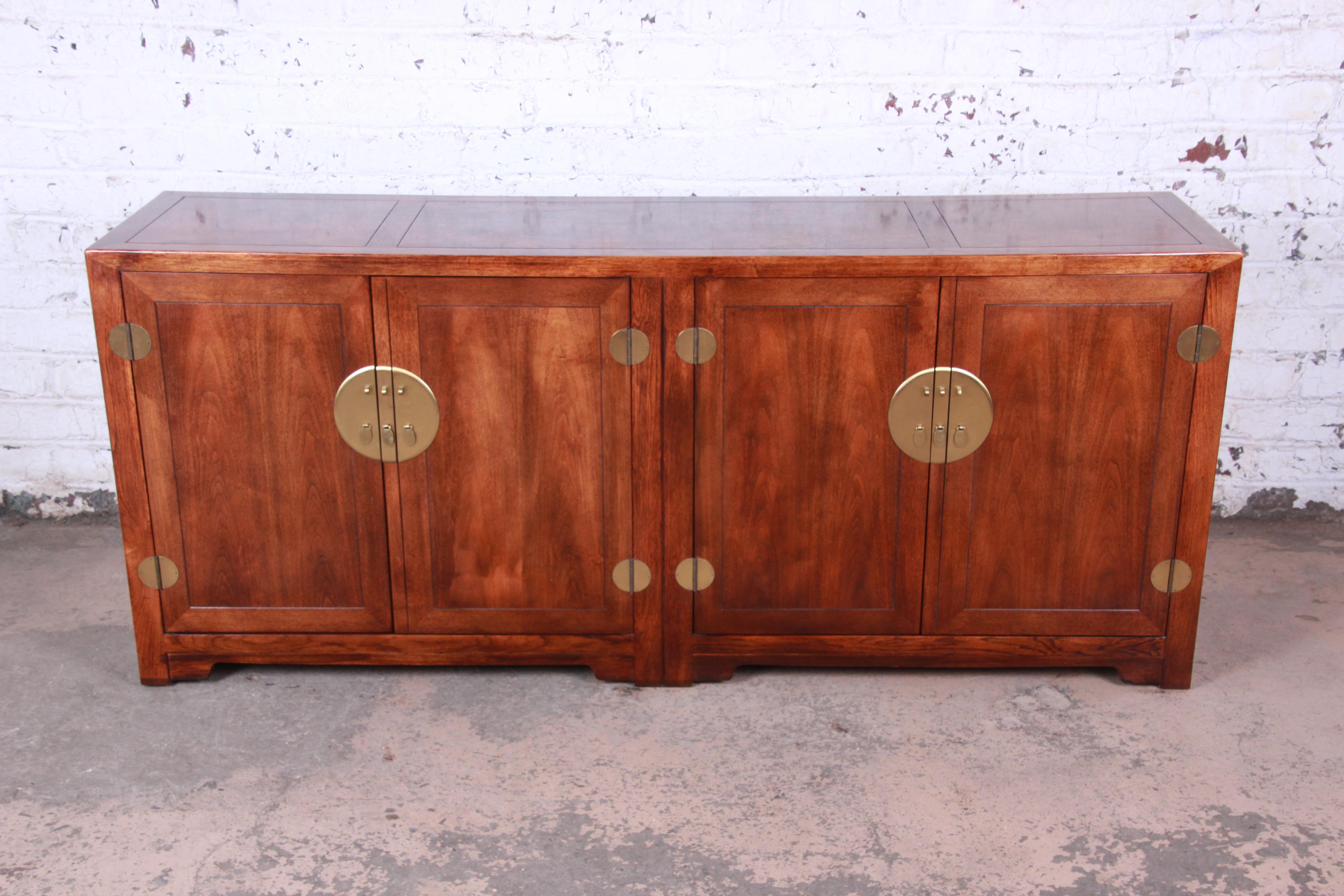 Offering an exceptional Hollywood Regency chinoiserie sideboard credenza designed by Michael Taylor for his Far East Collection for Baker Furniture. The sideboard features gorgeous walnut and burl wood grain and original brass Asian-inspired
