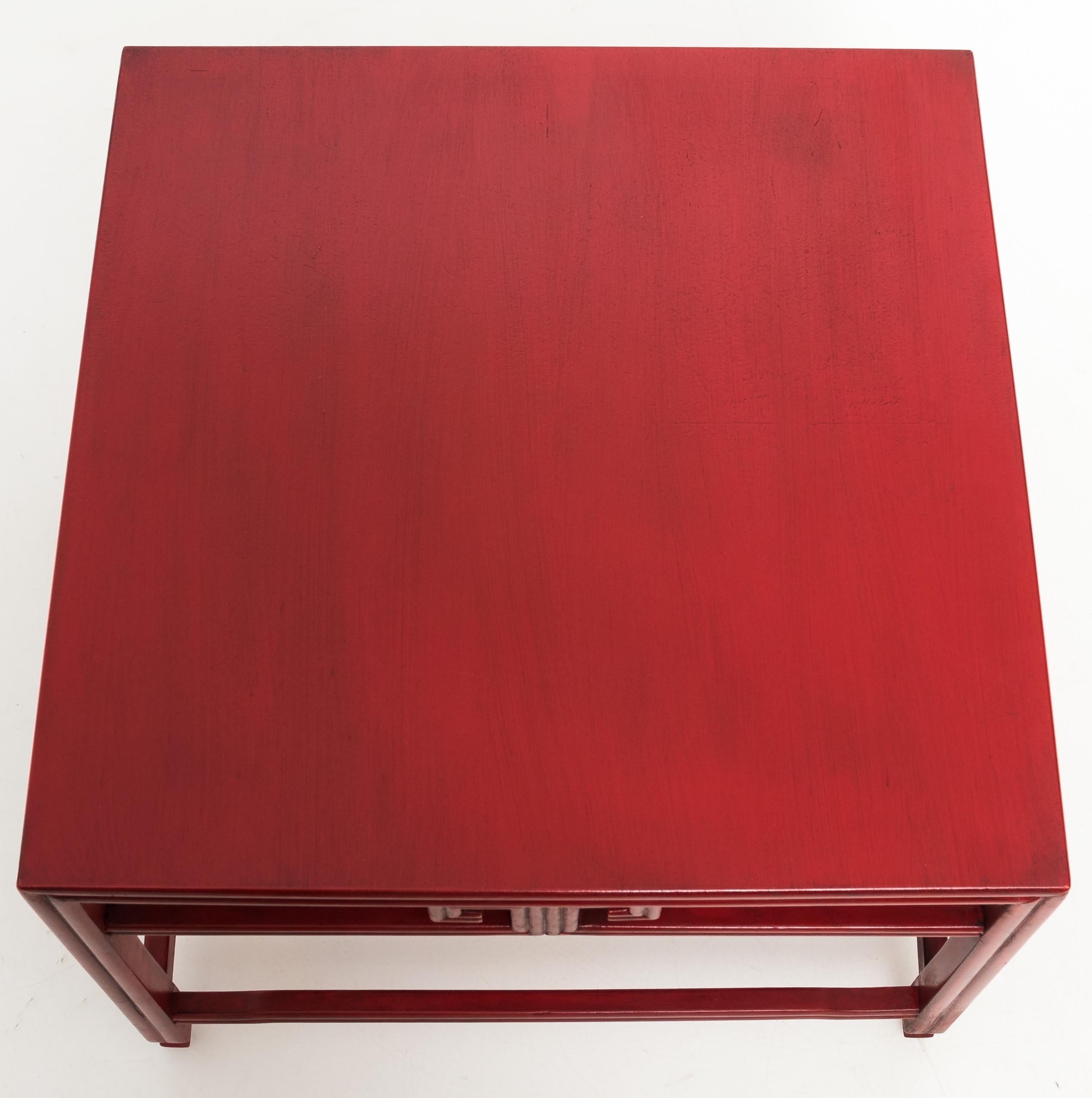 1970s occasional table by Michael Taylor for Baker. From the Far East collection. Solid oak construction with Greek key detailing. Newly refinished in antique red faux painted finish. Table retains Baker metal label.