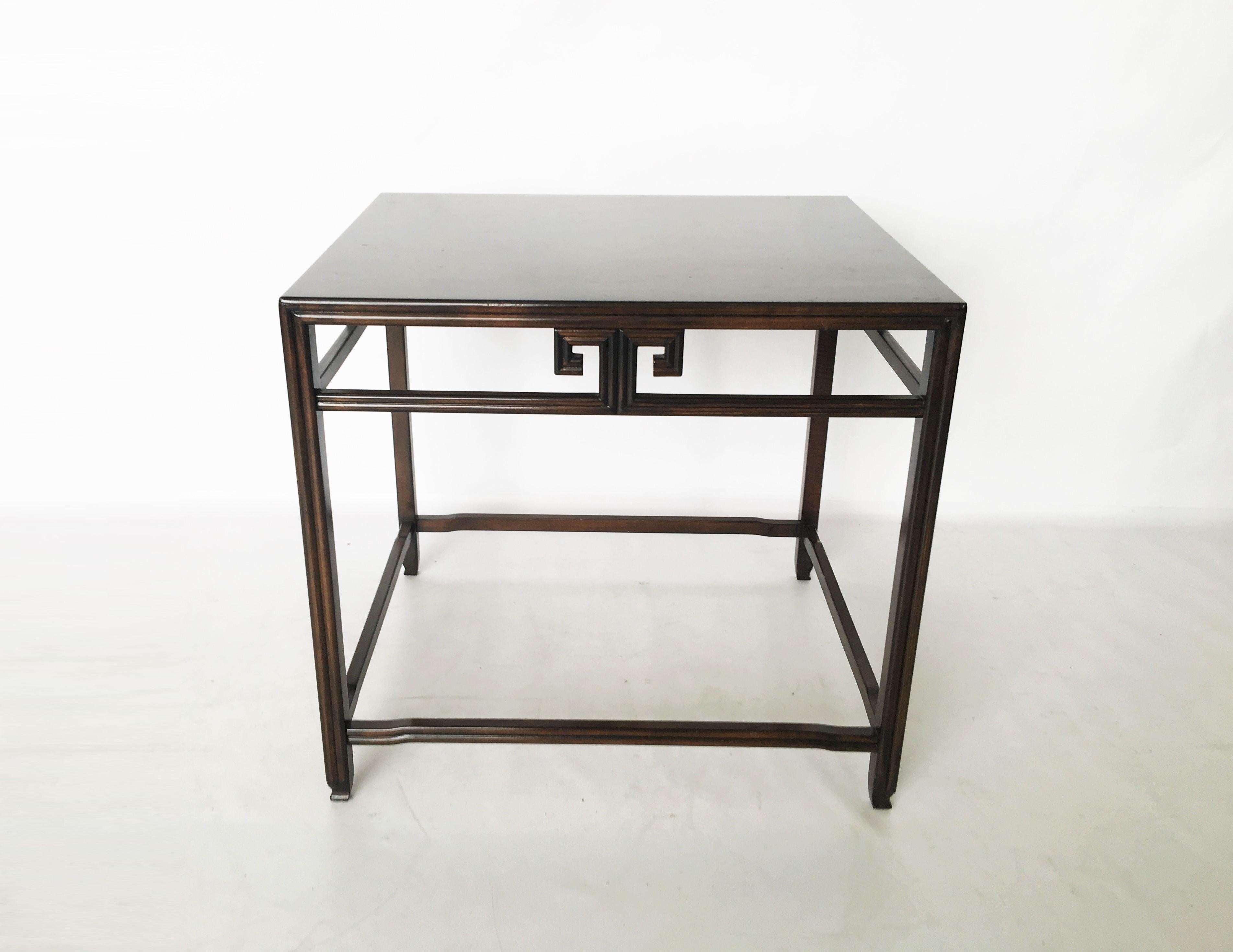 Pair of 1970s side tables by Michael Taylor for Baker from the Far East collection. Solid burl walnut construction with Greek key detailing in an ebonized finish. One table retains Baker metal label.